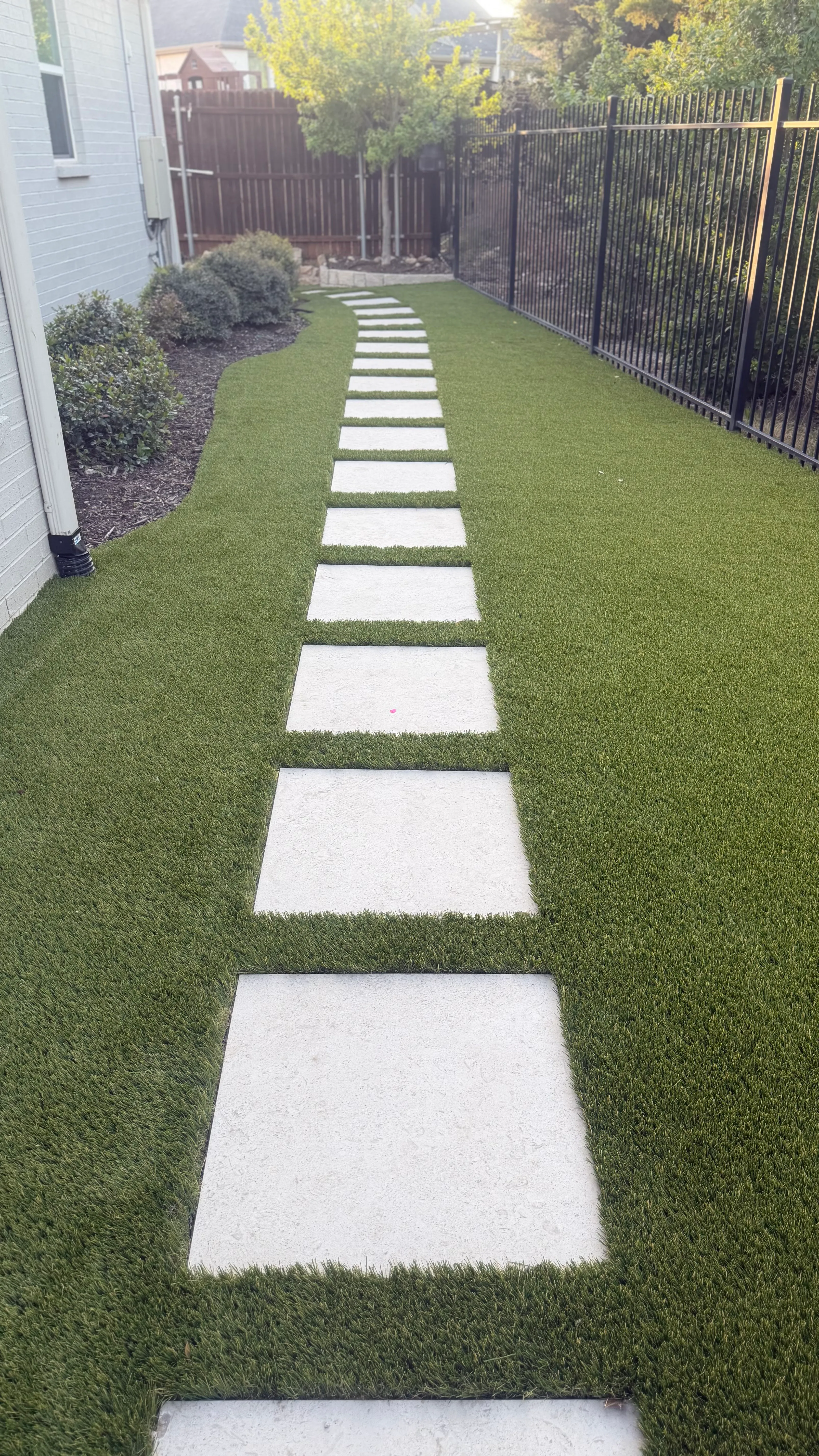 Parks of Aledo backyard conversion: 1,750 SF of turf that disappears into the greenbelt, plus a paver walkway — after