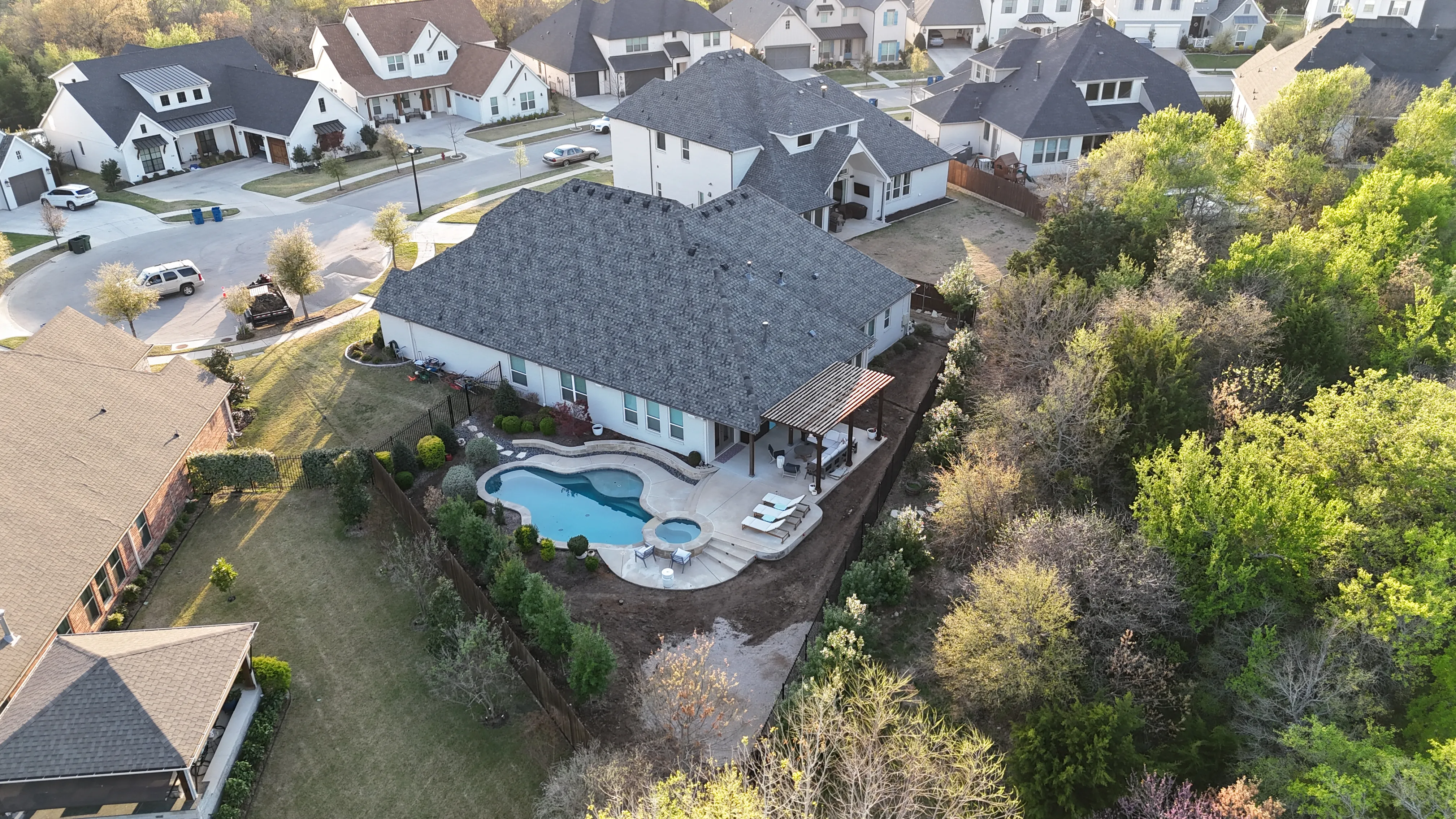 Construction 3 — Parks of Aledo backyard conversion: 1,750 SF of turf that disappears into the greenbelt, plus a paver walkway