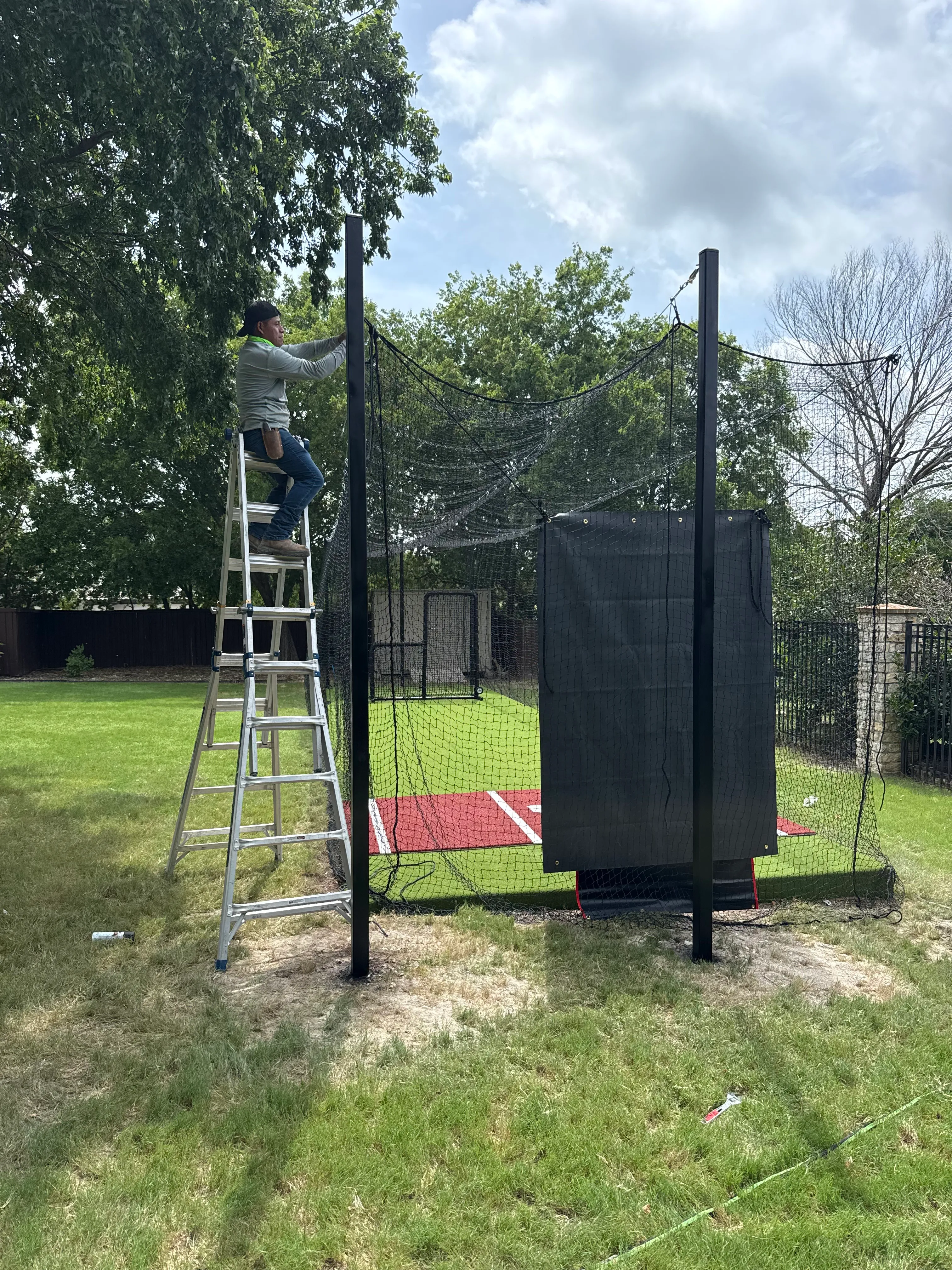 Construction 2 — Allen backyard batting cage: Cimarron 55x12x12 net on steel posts, crushed-concrete base, clay batter's box