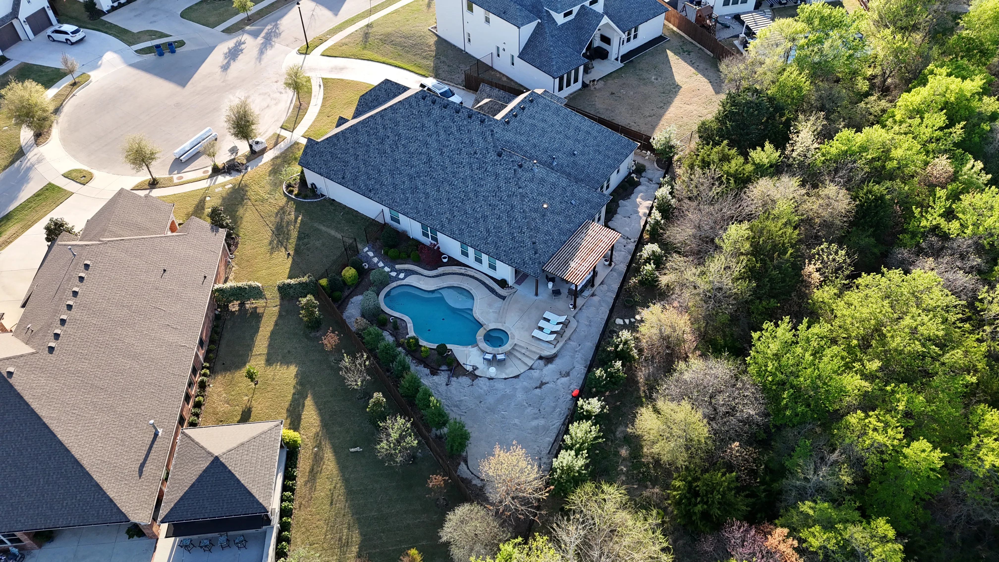 Construction 4 — Parks of Aledo backyard conversion: 1,750 SF of turf that disappears into the greenbelt, plus a paver walkway