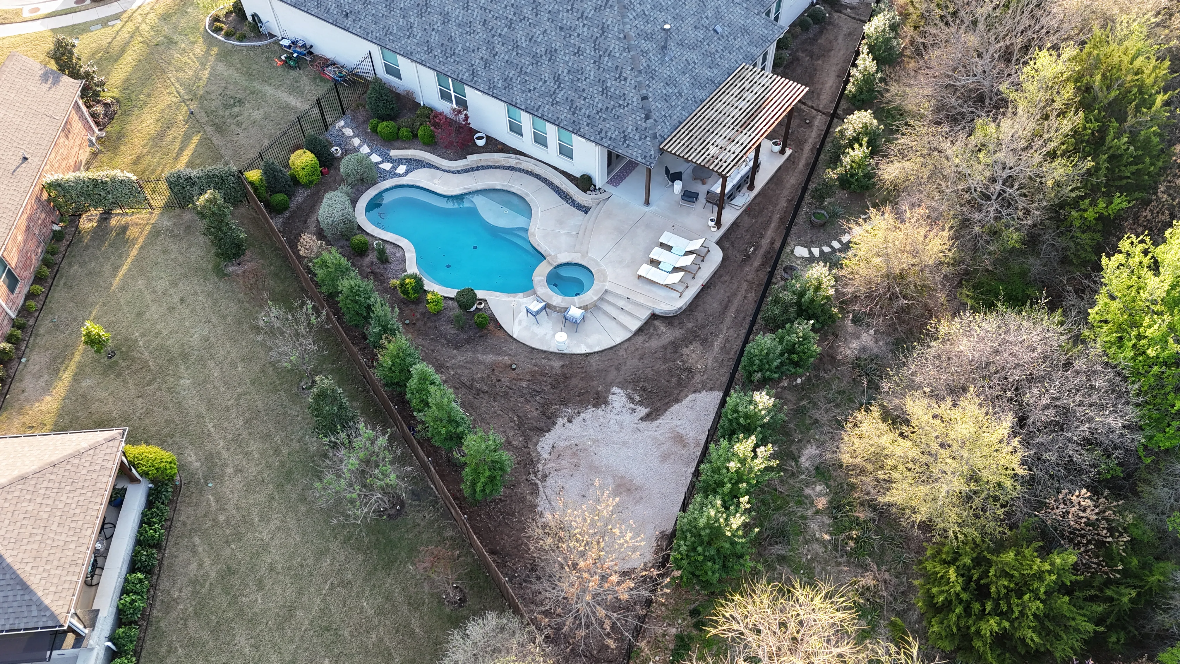 Construction 5 — Parks of Aledo backyard conversion: 1,750 SF of turf that disappears into the greenbelt, plus a paver walkway
