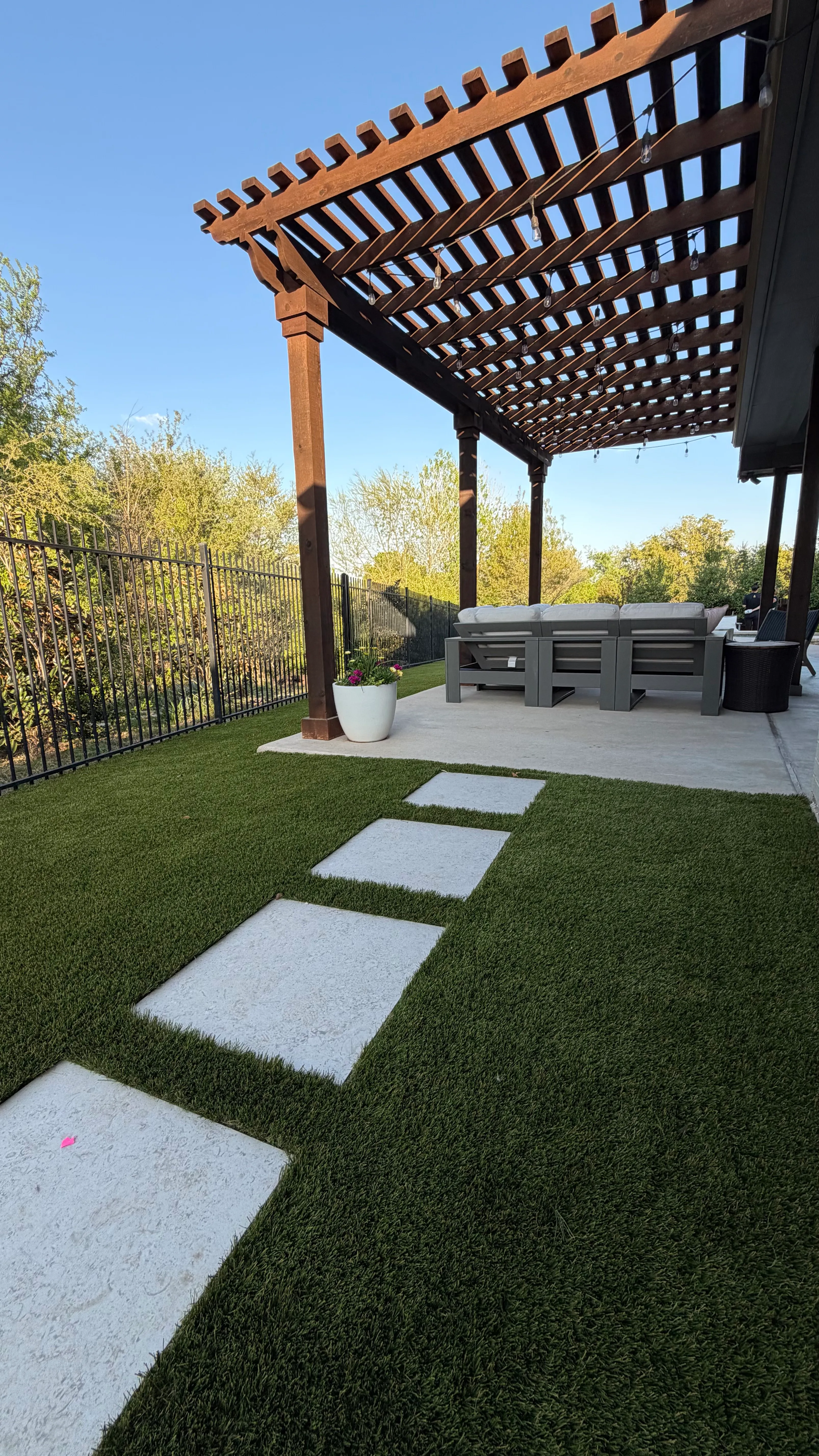 After 9 — Parks of Aledo backyard conversion: 1,750 SF of turf that disappears into the greenbelt, plus a paver walkway