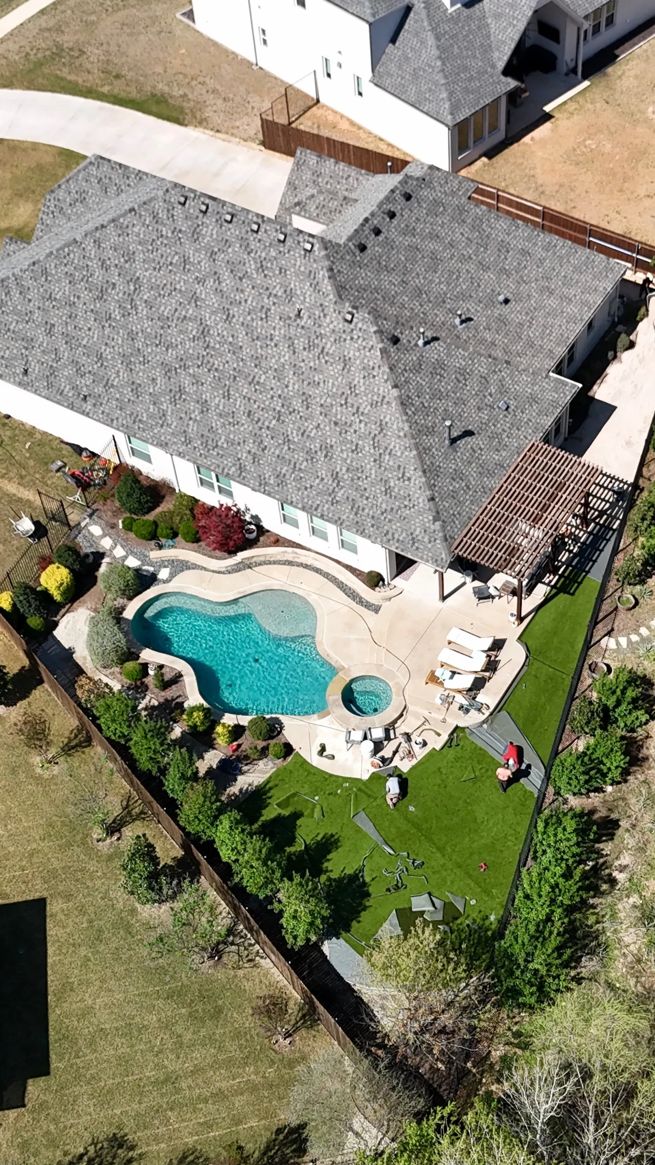 Construction 6 — Parks of Aledo backyard conversion: 1,750 SF of turf that disappears into the greenbelt, plus a paver walkway