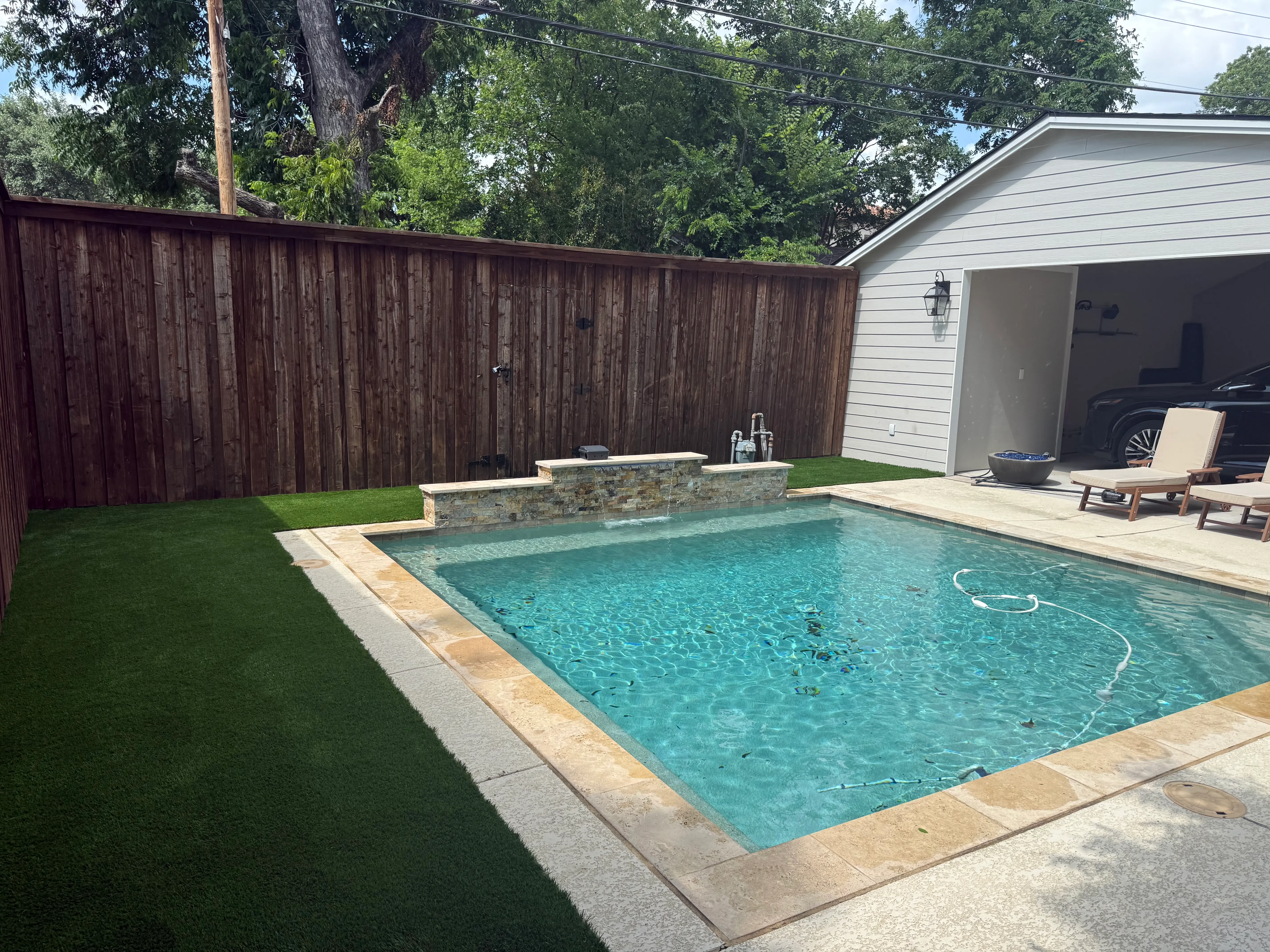 Monticello backyard: rocks out, Malibu 80 in — a Tudor glow-up off Camp Bowie