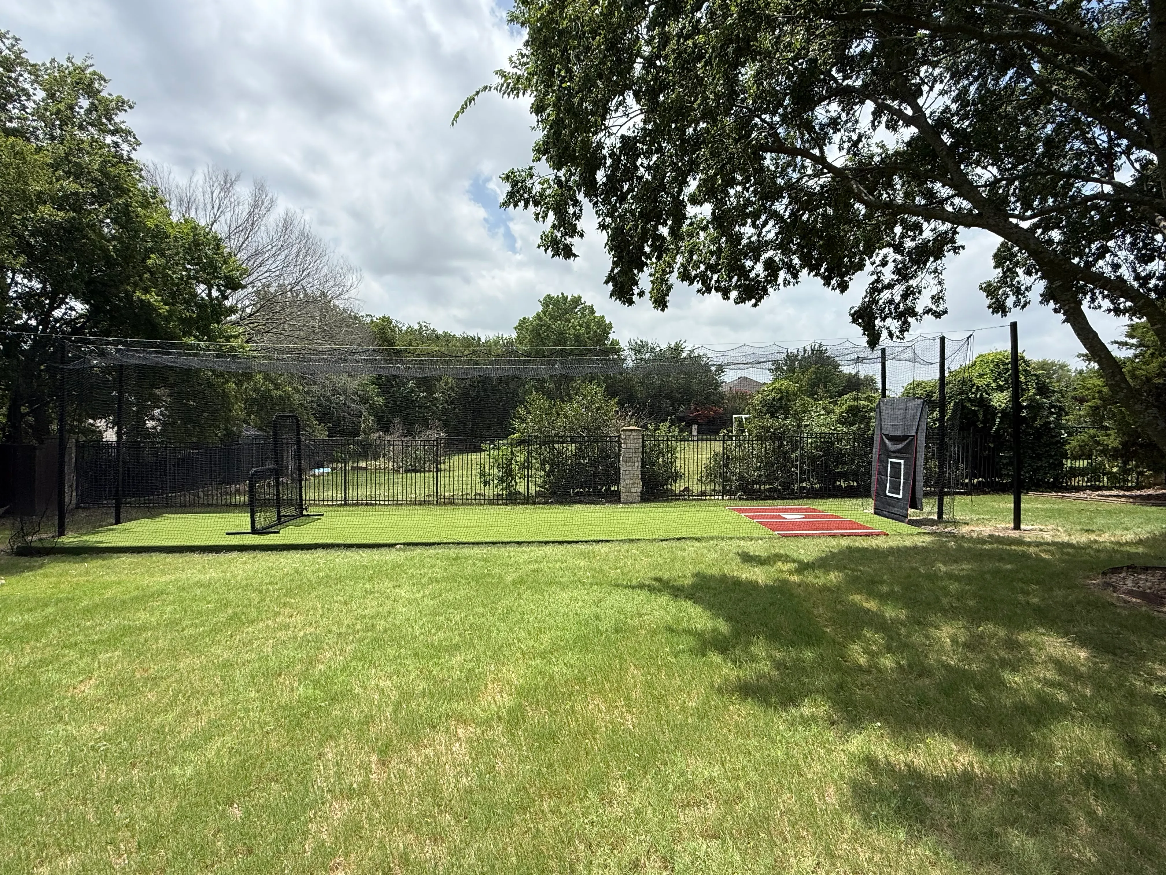 Allen backyard batting cage: Cimarron 55x12x12 net on steel posts, crushed-concrete base, clay batter's box