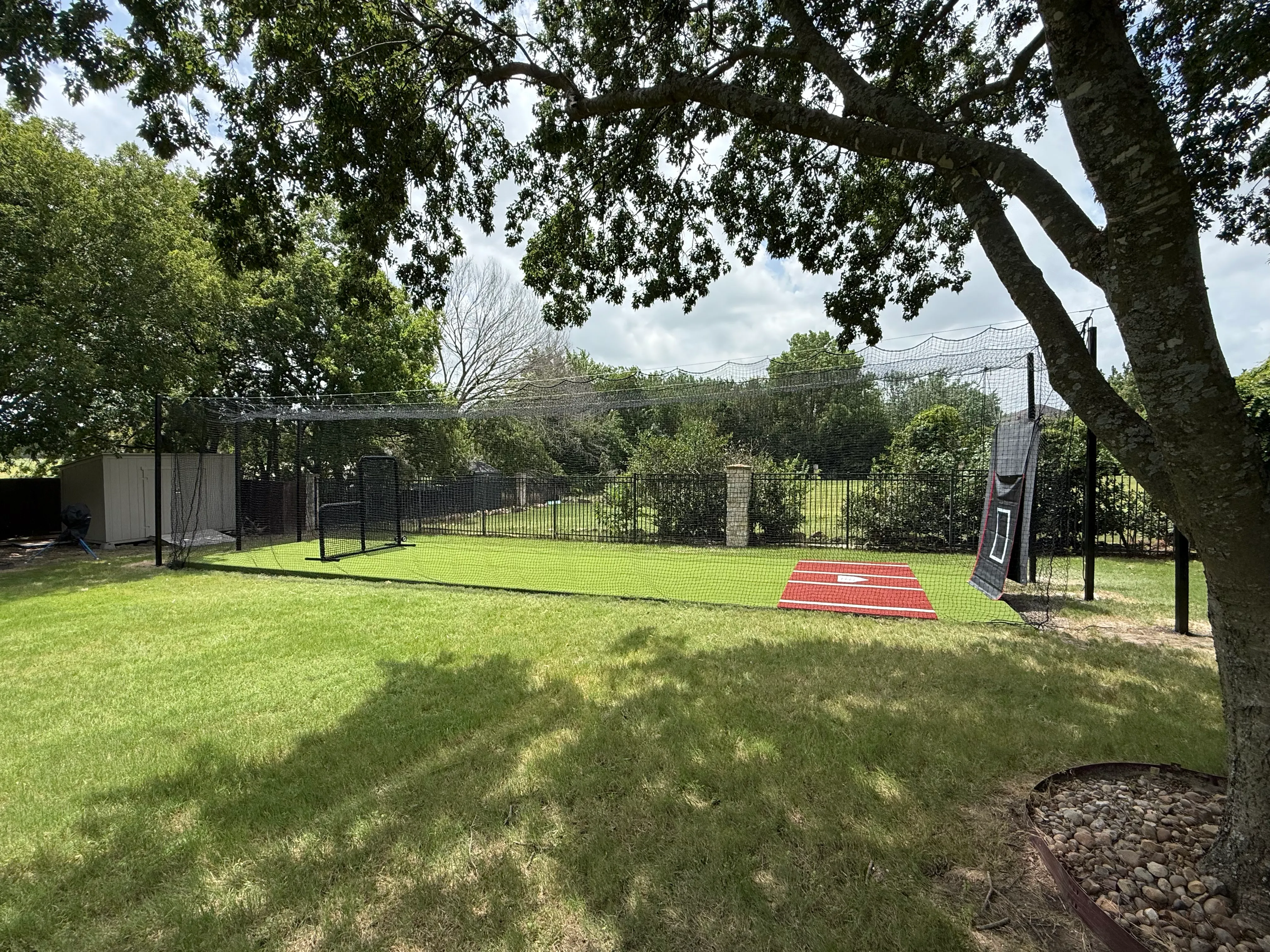 Allen backyard batting cage: Cimarron 55x12x12 net on steel posts, crushed-concrete base, clay batter's box feature 2