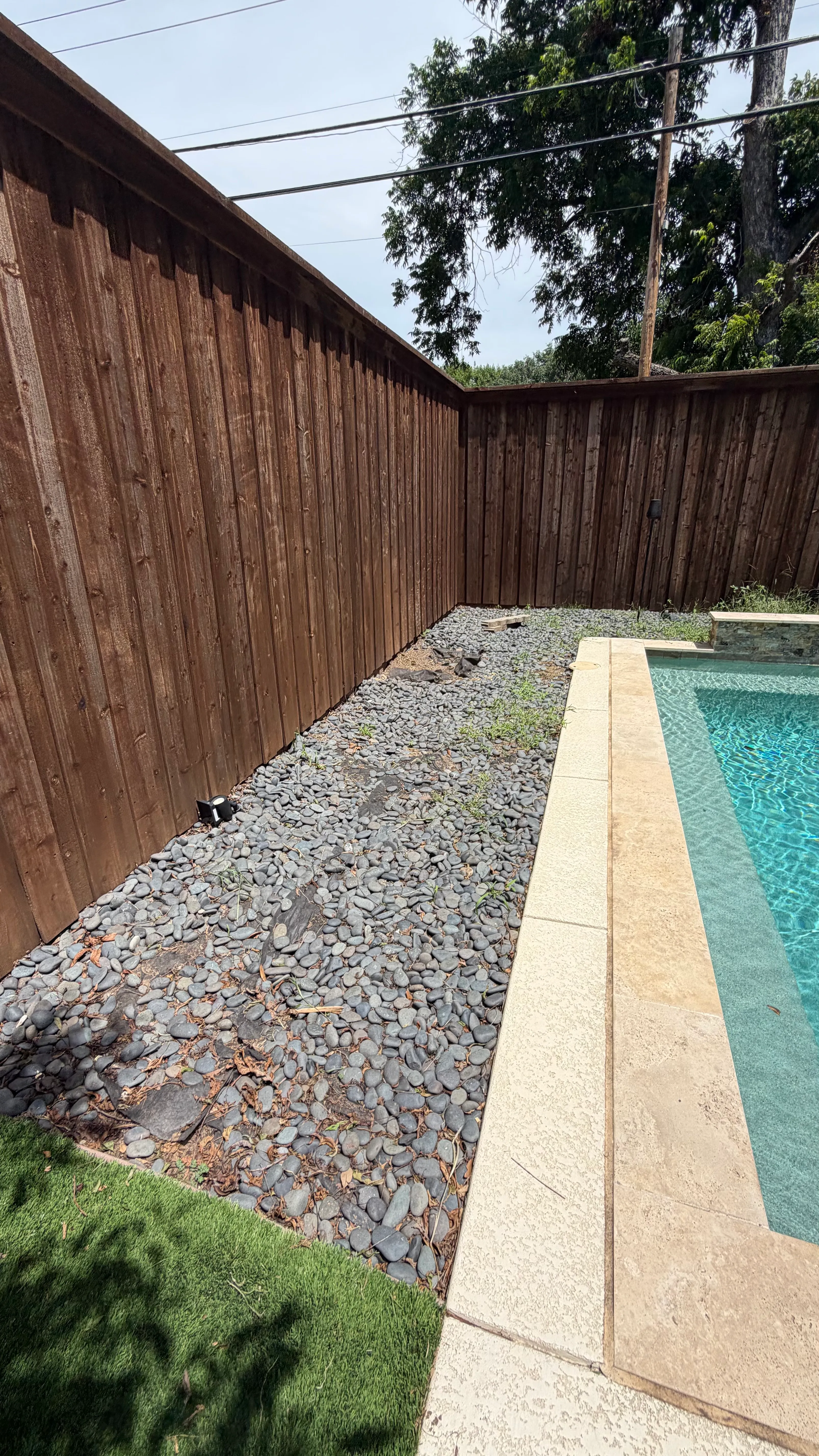Monticello backyard: rocks out, Malibu 80 in — a Tudor glow-up off Camp Bowie — before
