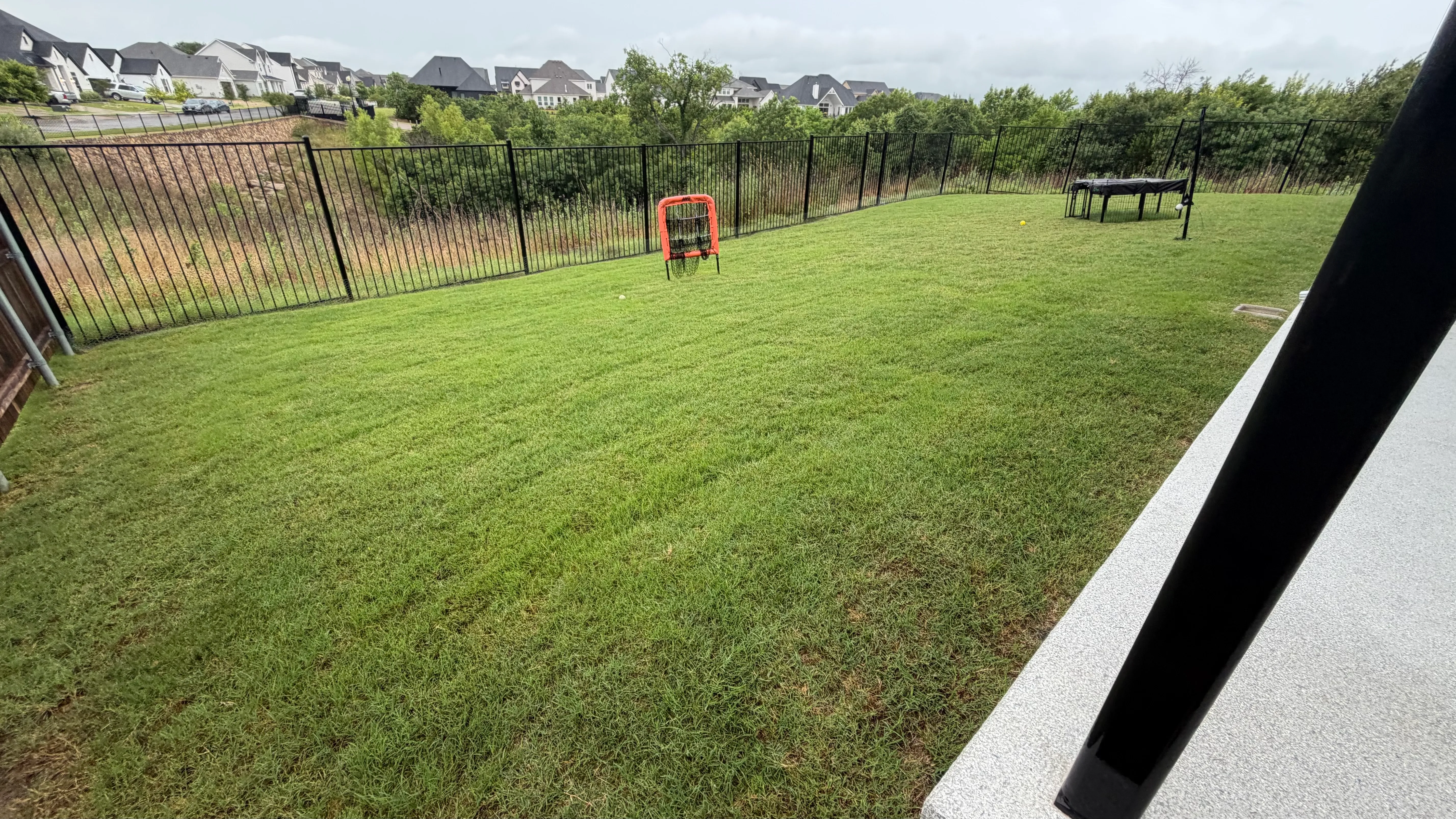 Before 3 — Parks of Aledo full backyard: 2,900 SF of Rymar TriBlend that disappears into the greenbelt