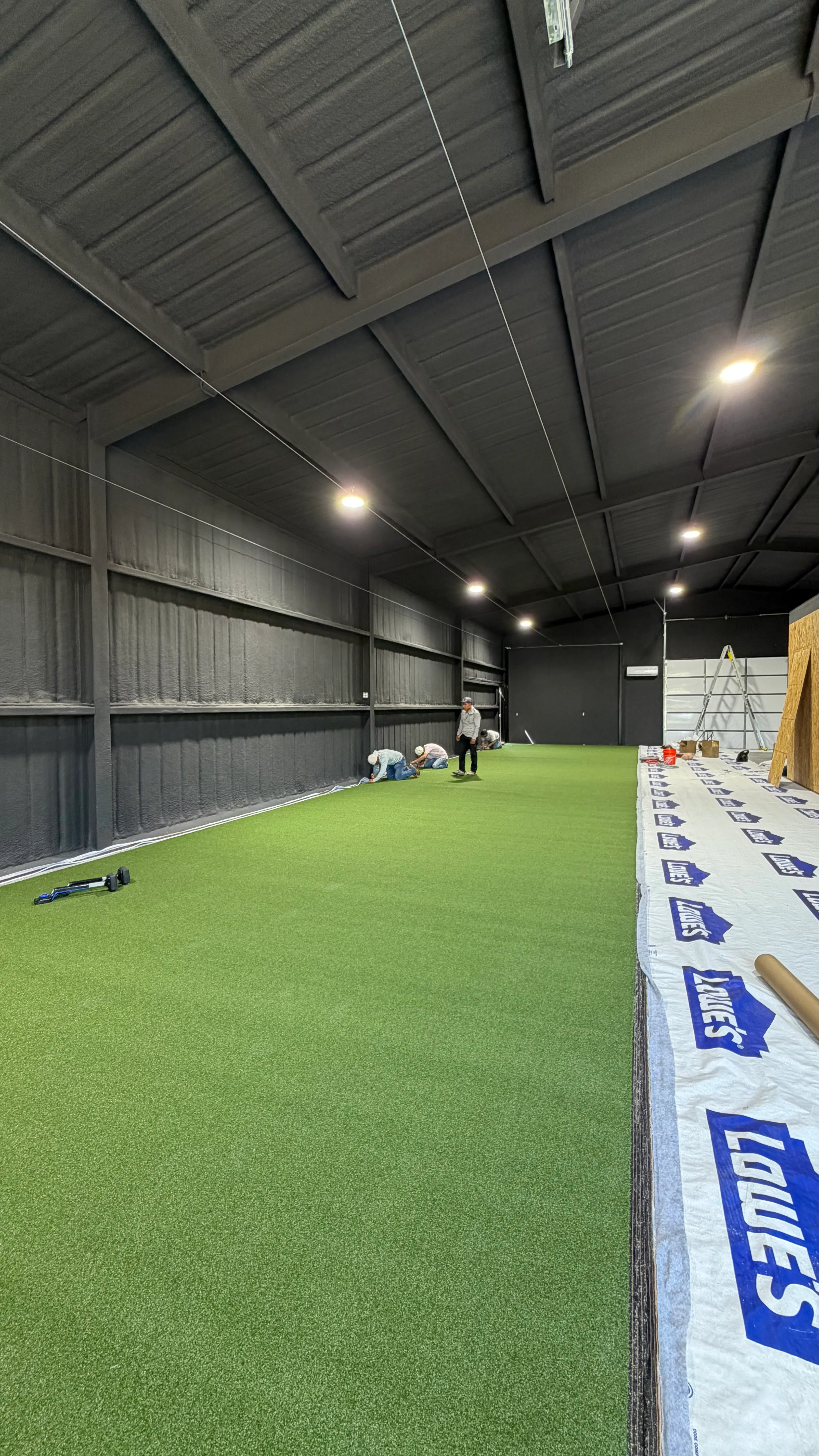Construction 4 — Aledo backyard barn batting cage: 70' full-length retractable Cimarron net, Performance Pro turf, clay batter's box