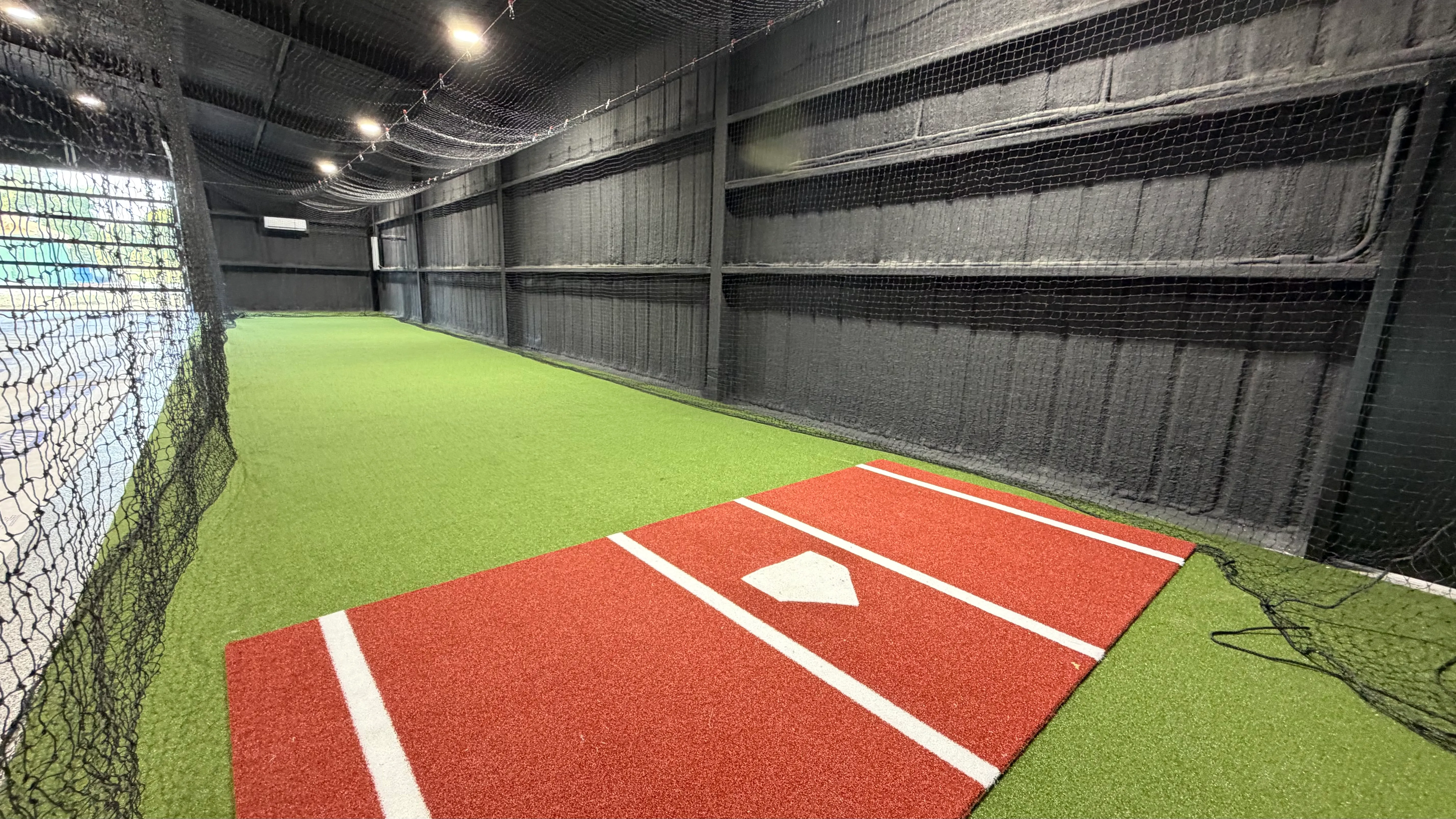 After 9 — Aledo backyard barn batting cage: 70' full-length retractable Cimarron net, Performance Pro turf, clay batter's box
