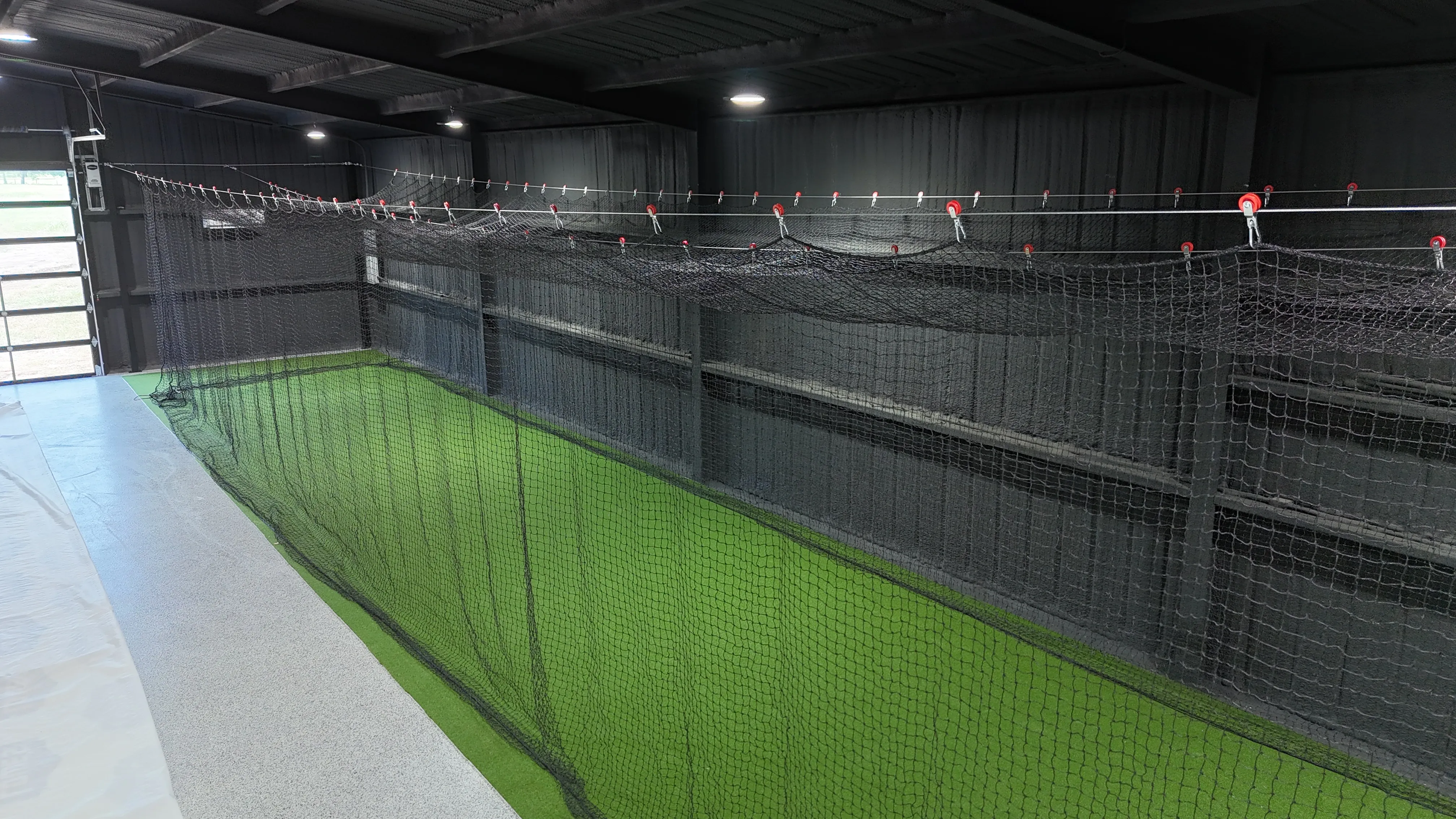 Aledo backyard barn batting cage: 70' full-length retractable Cimarron net, Performance Pro turf, clay batter's box