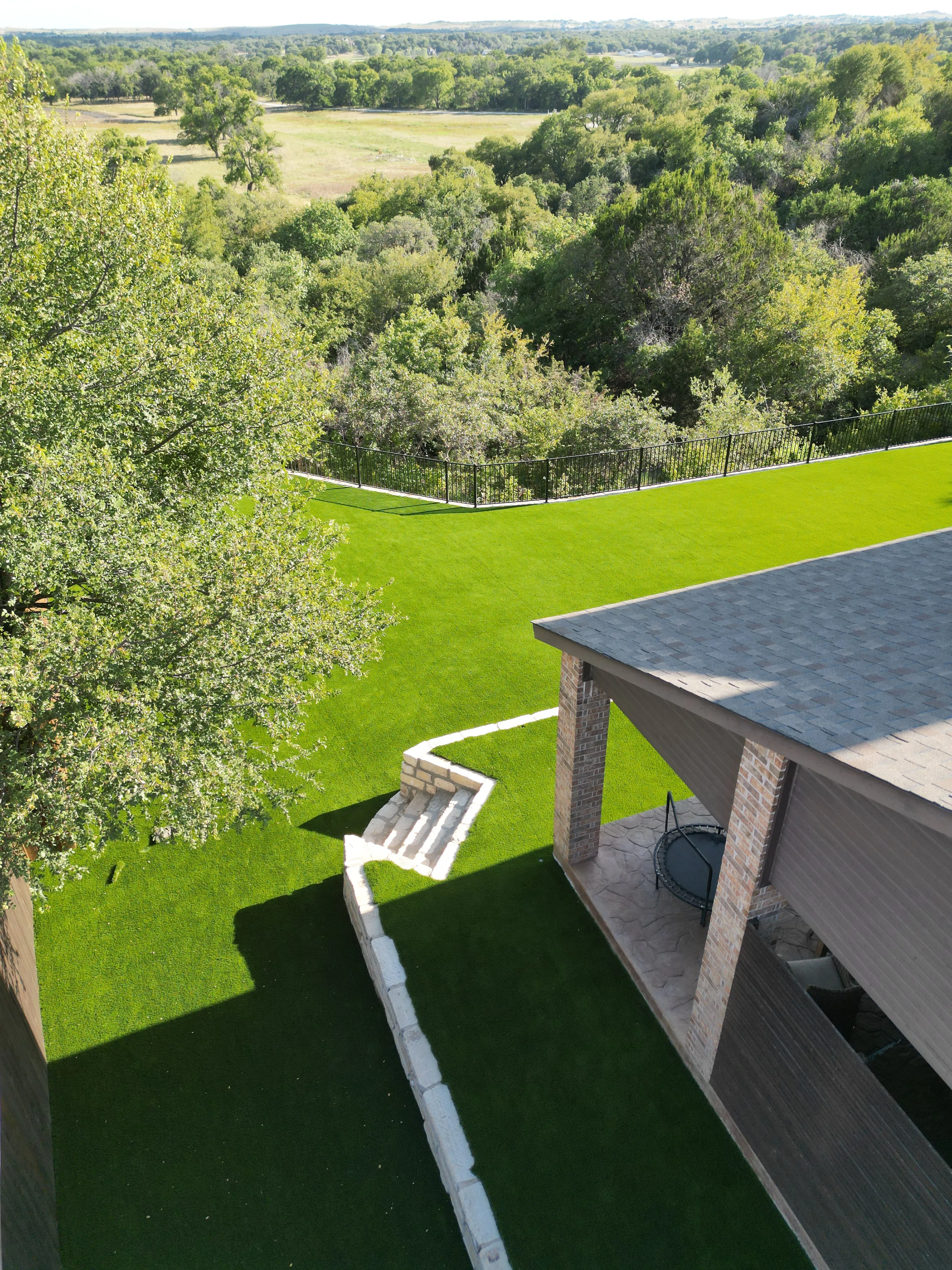 Aledo tiered backyard build: 606 SF Millsap retaining wall + 5,600 SF Bermuda Pro turf