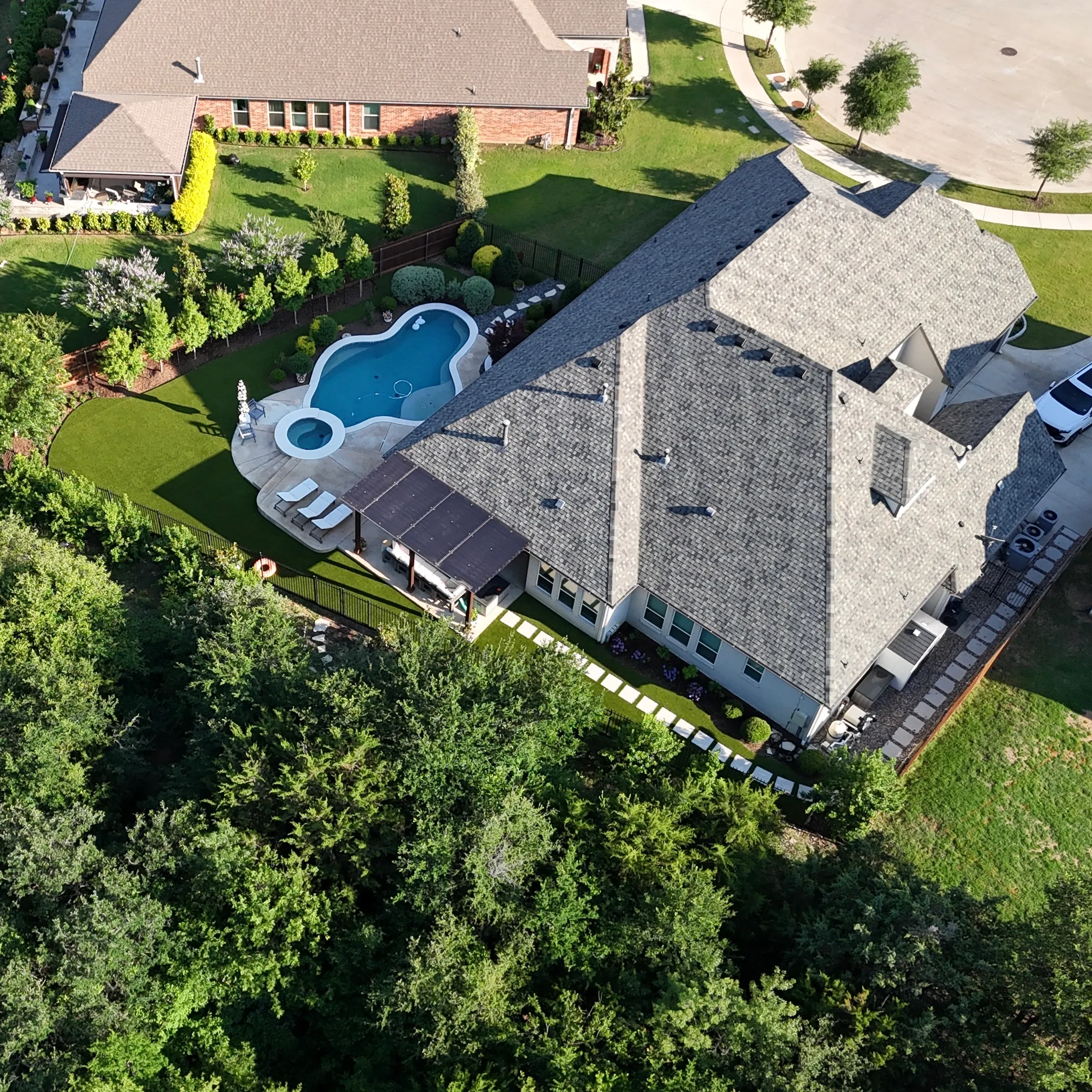 Parks of Aledo backyard conversion: 1,750 SF of turf that disappears into the greenbelt, plus a paver walkway