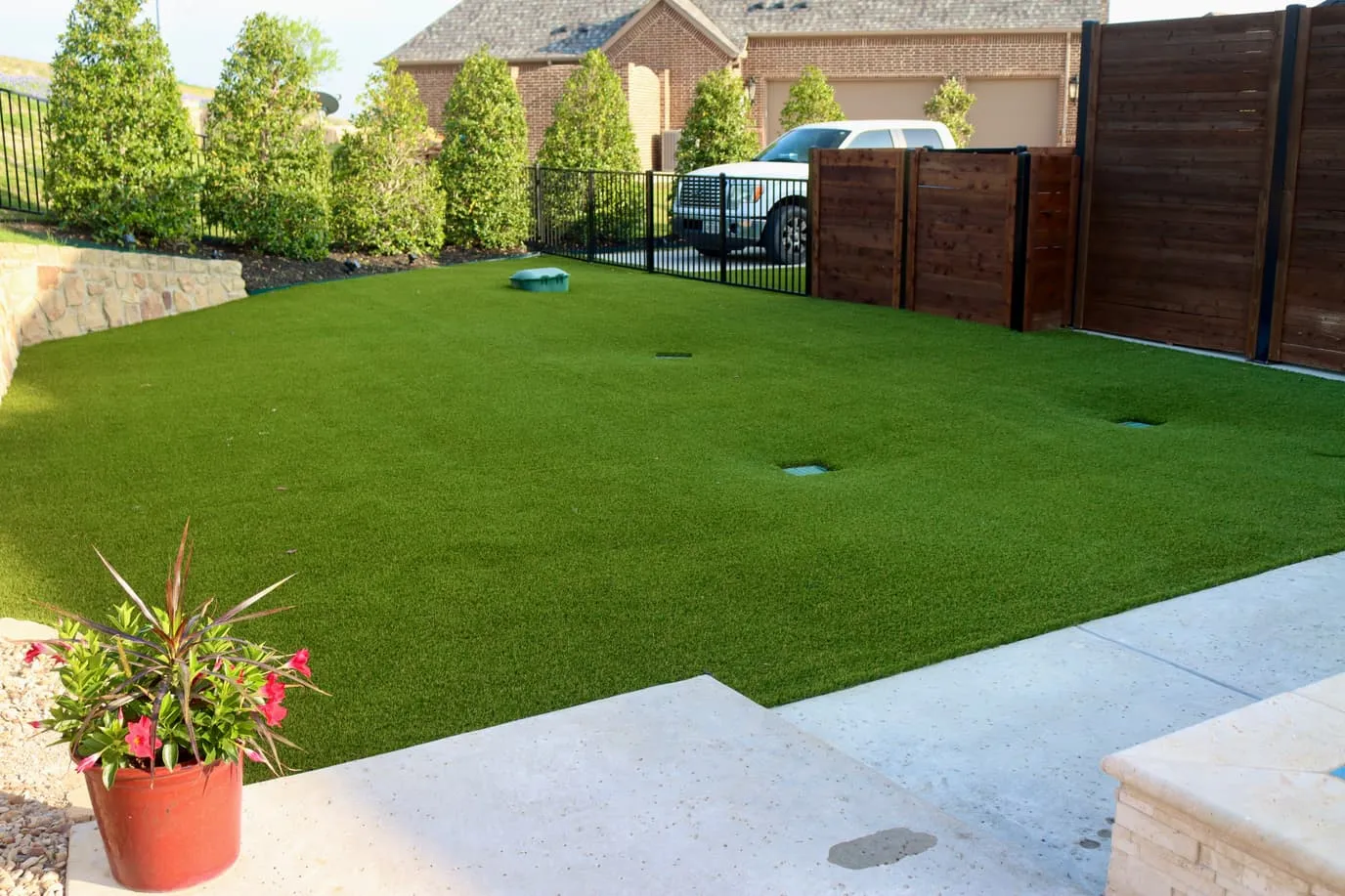 Backyard artificial putting green with cups in North Texas