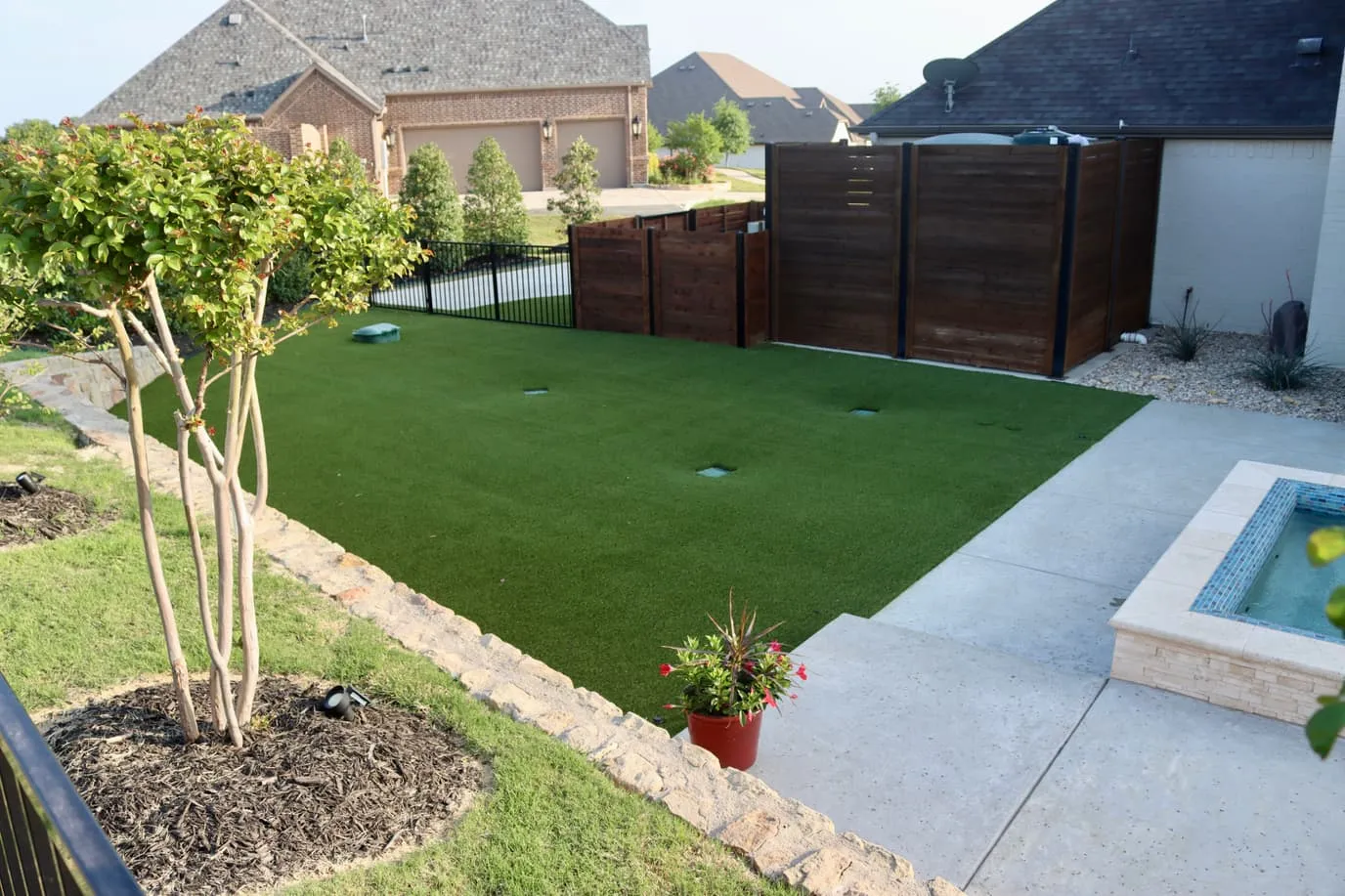 Luxury Spanish-style backyard pool with artificial turf at sunset in DFW