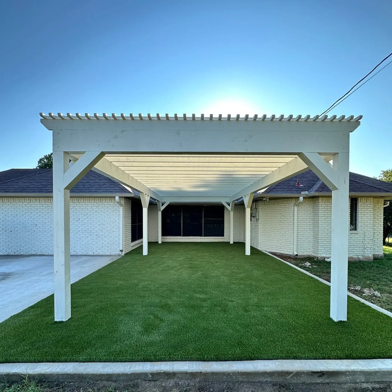 Backyard playset with green slide on artificial turf