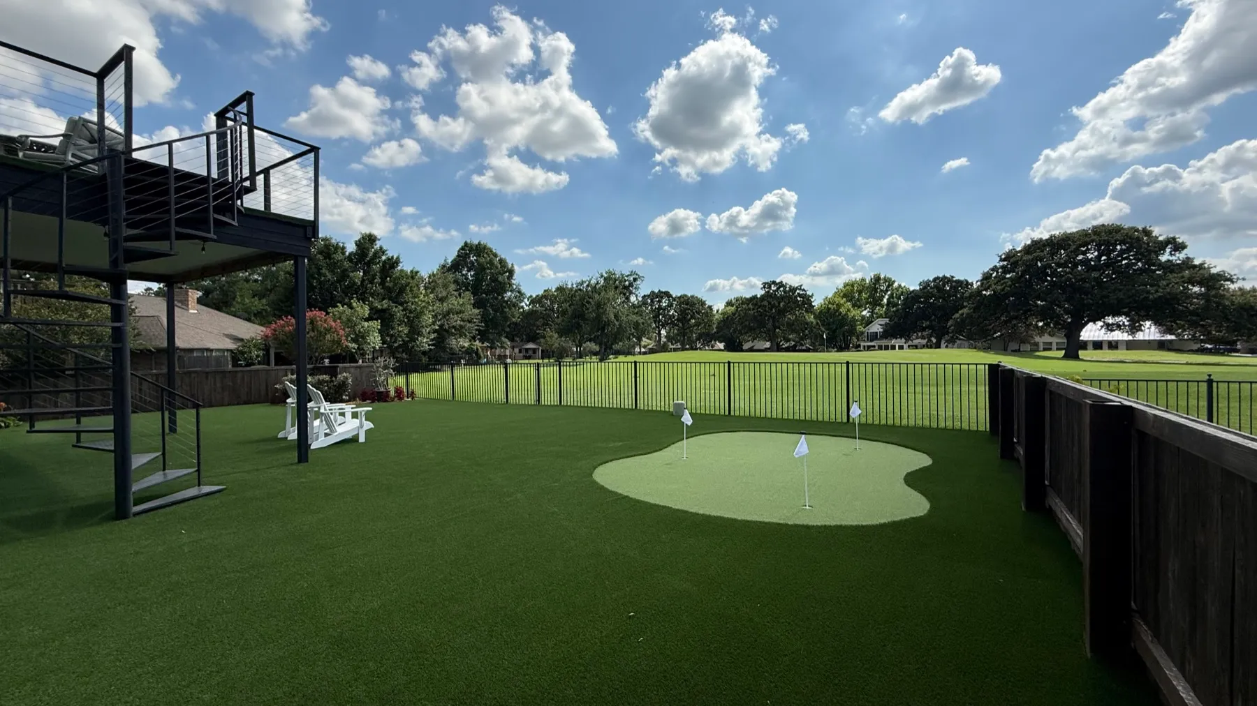 Backyard putting green with open course backdrop in DFW