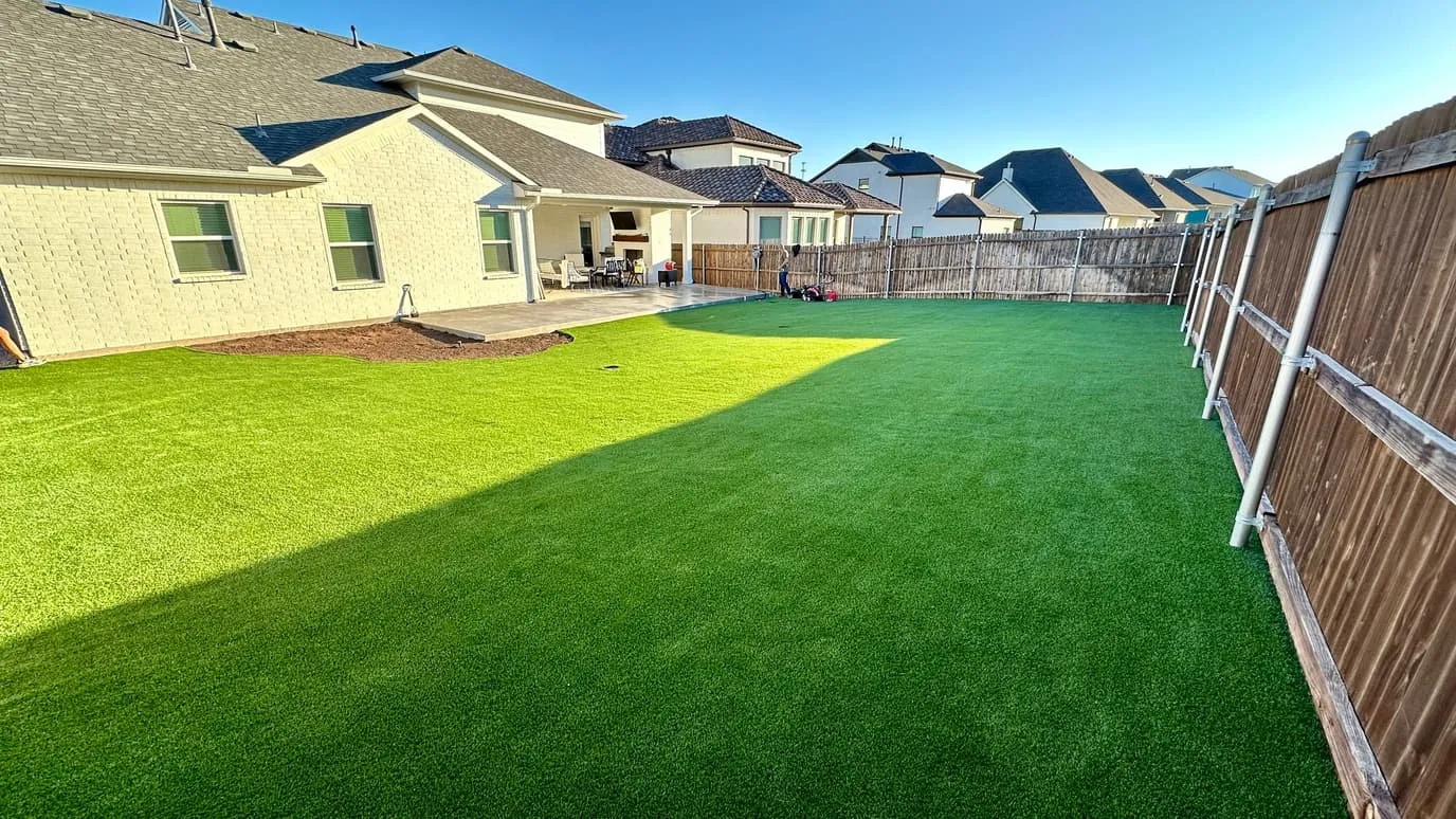 Backyard artificial turf replacing worn sod in DFW