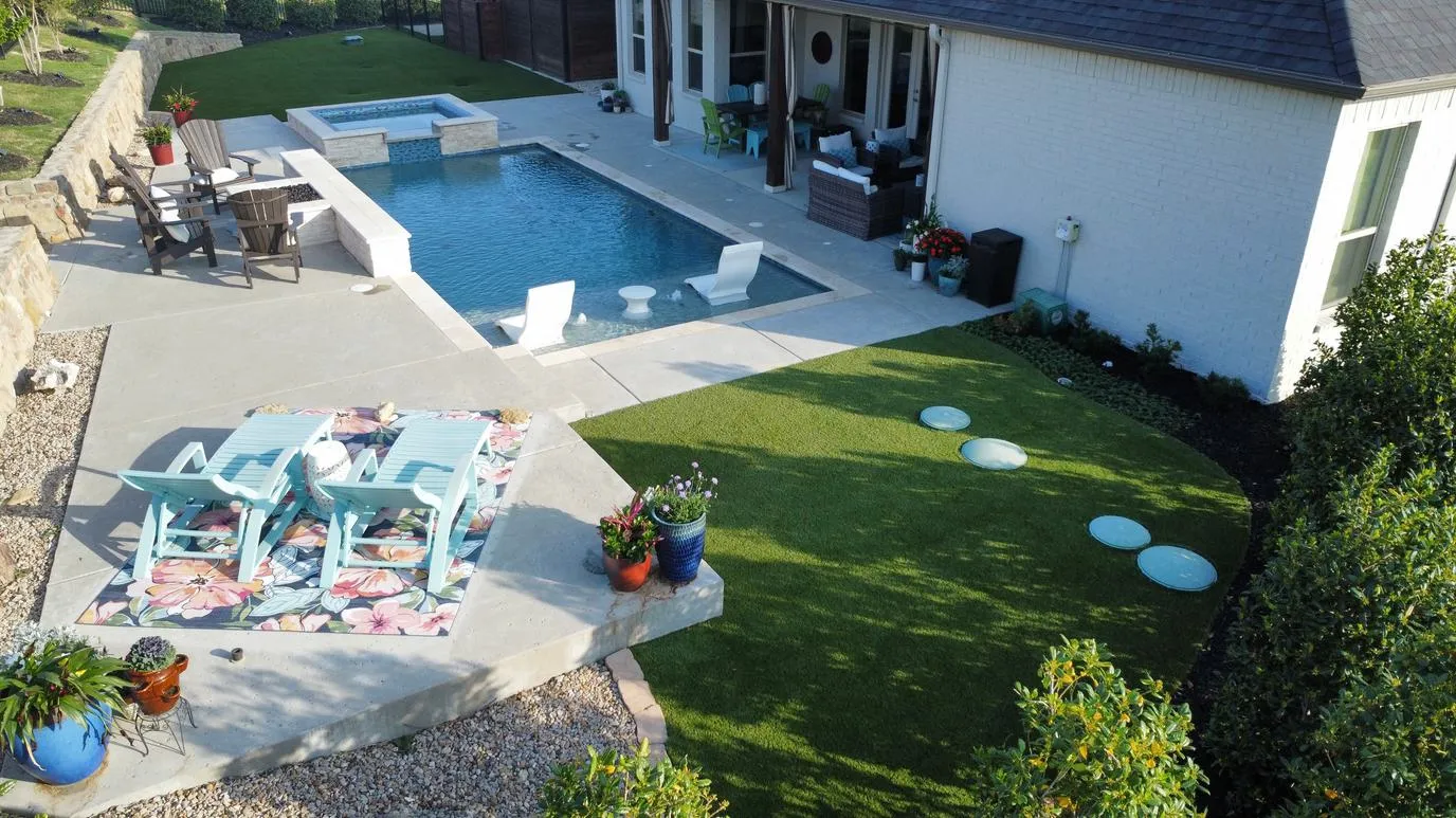 Aerial pool and artificial turf with patio loungers