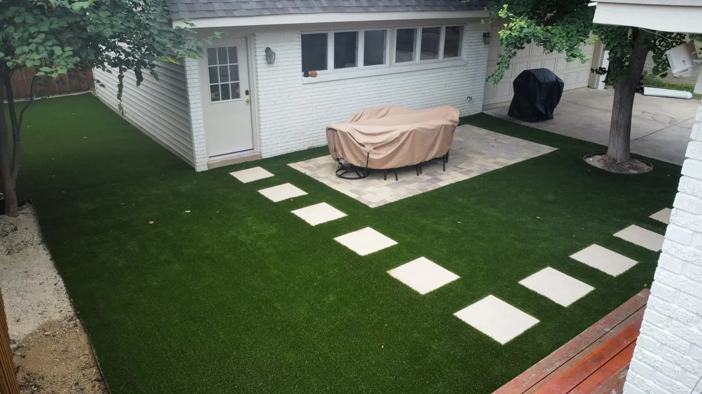 Backyard artificial turf with stepping-stone path and patio in Parker County