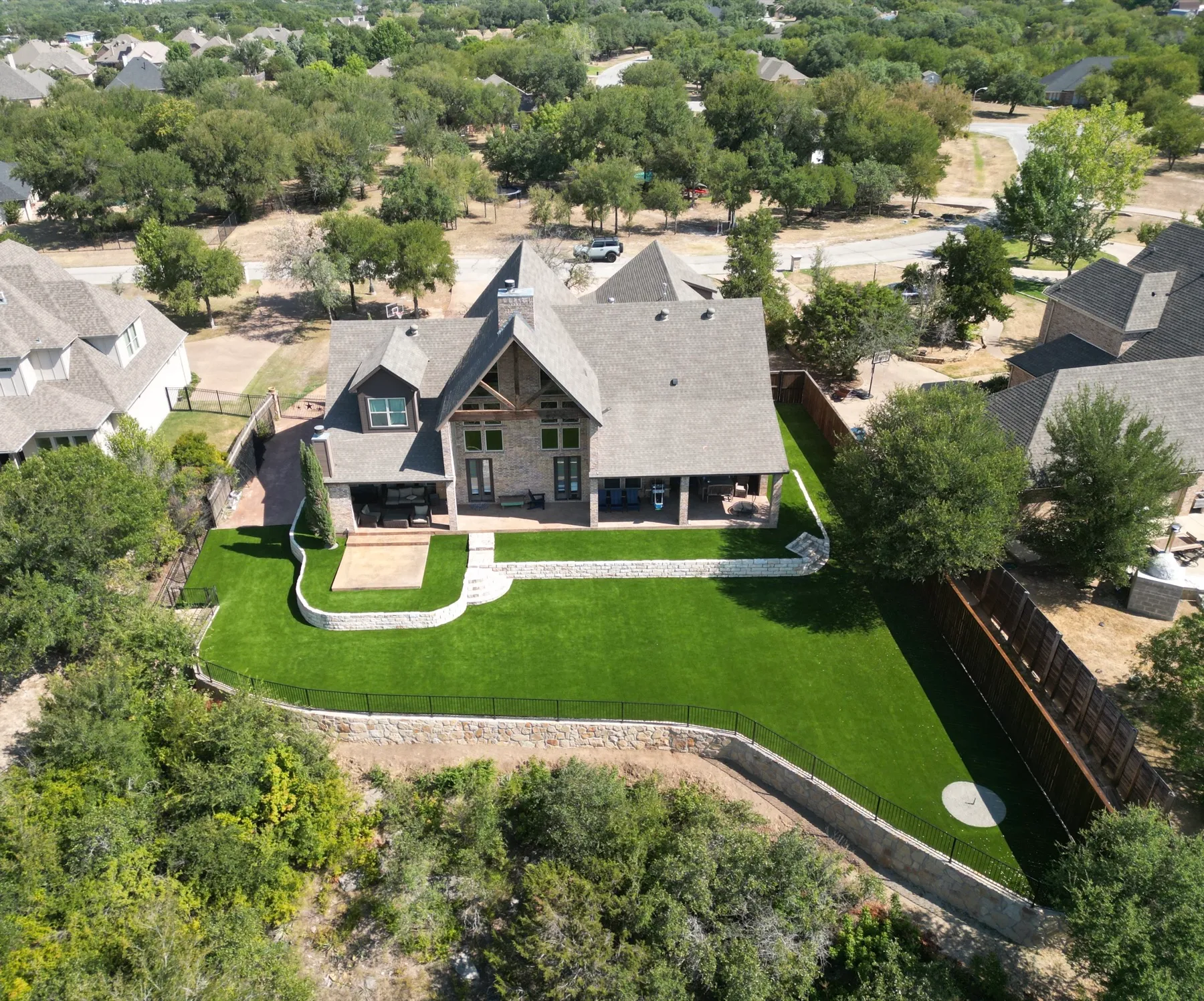 Aerial estate backyard with artificial turf lawn in Aledo TX