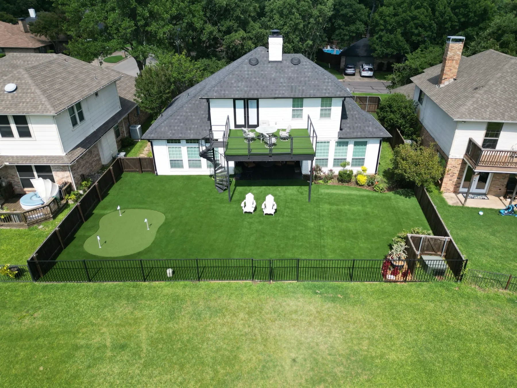 Aerial backyard putting green with home deck in Mansfield DFW