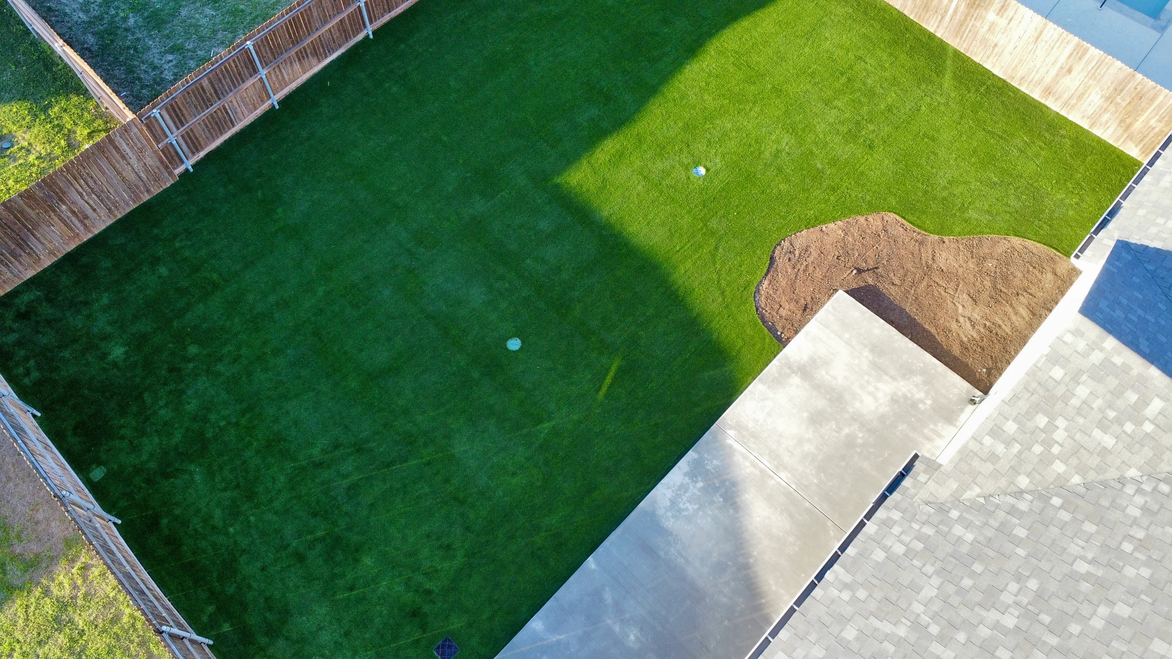 Aerial of finished artificial turf backyard lawn in DFW