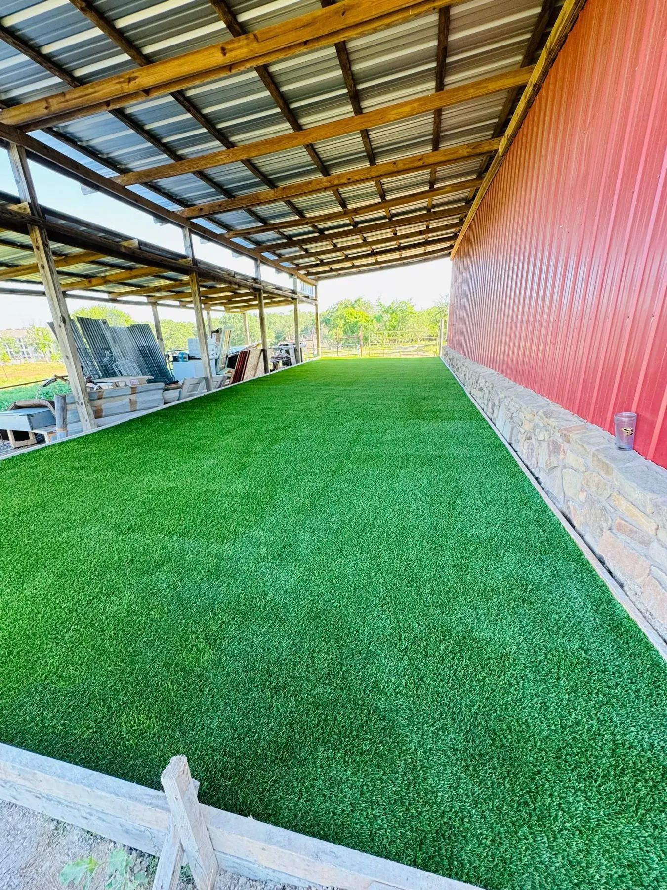 Batting cage with artificial turf installation