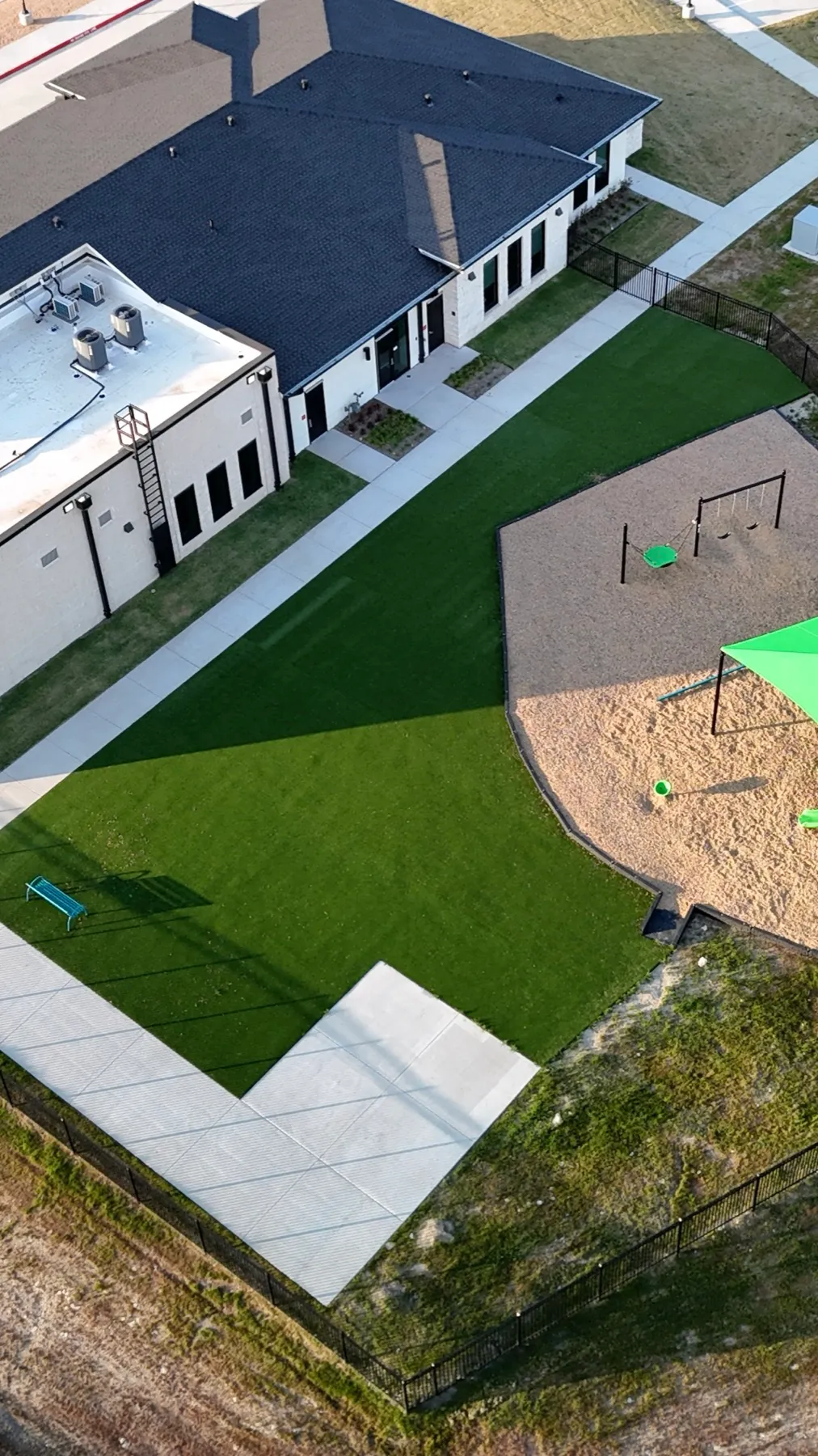 Vertical aerial of Aledo TX school turf play yard and playground
