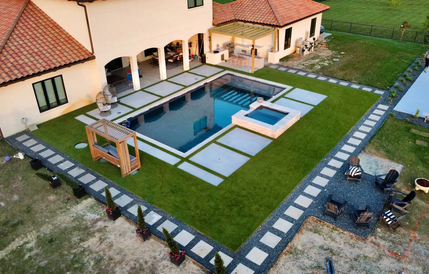Aerial luxury pool with spa and artificial turf stepping pads