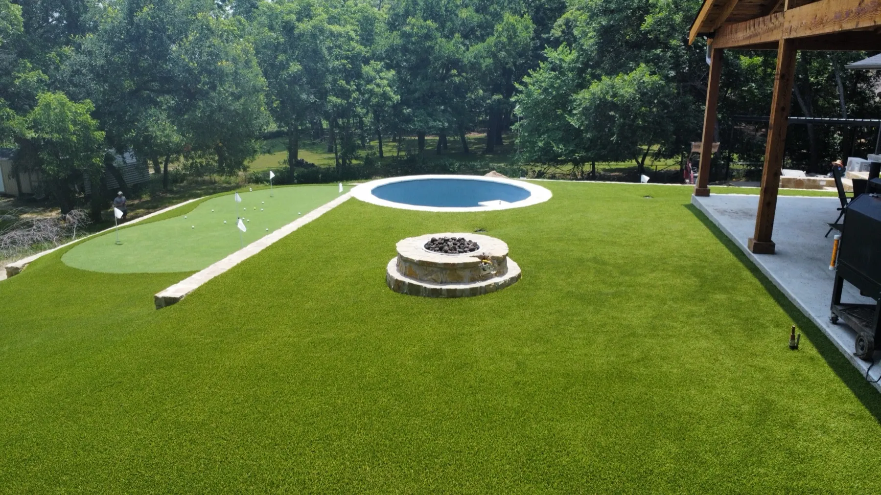 Aerial commercial pet-turf area with paw-print graphics