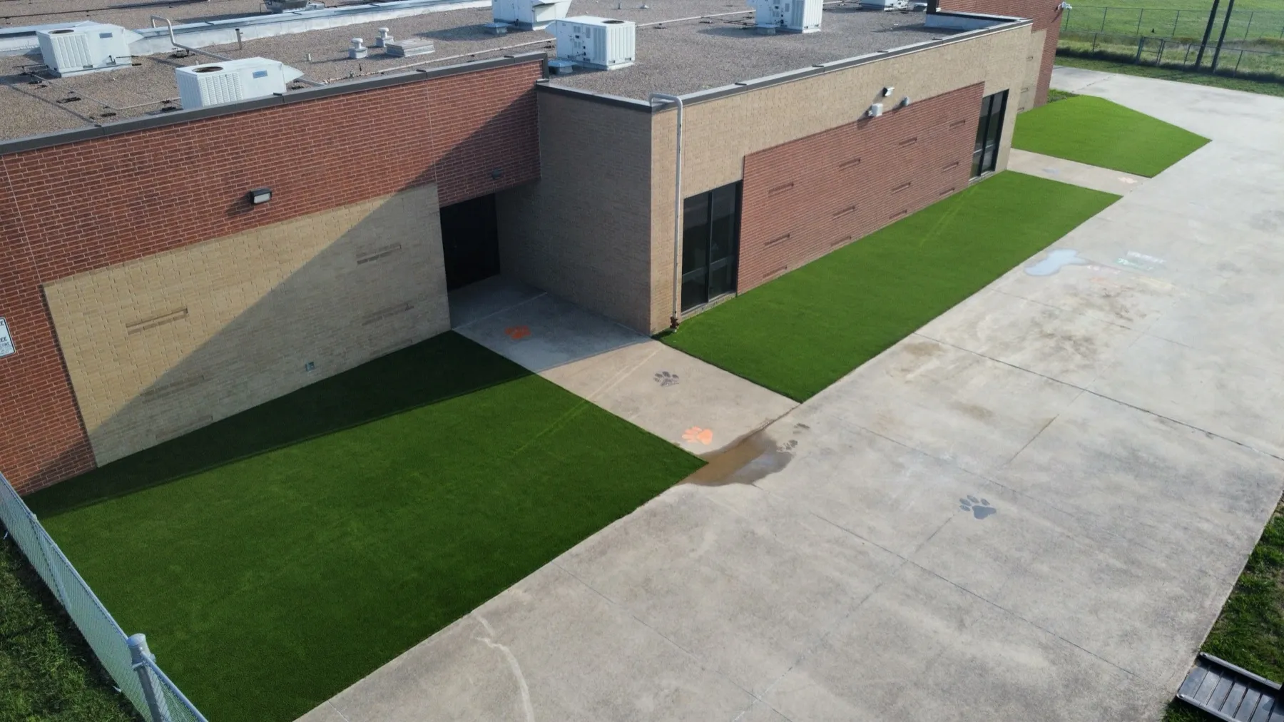 Aerial school campus with artificial turf landscape borders