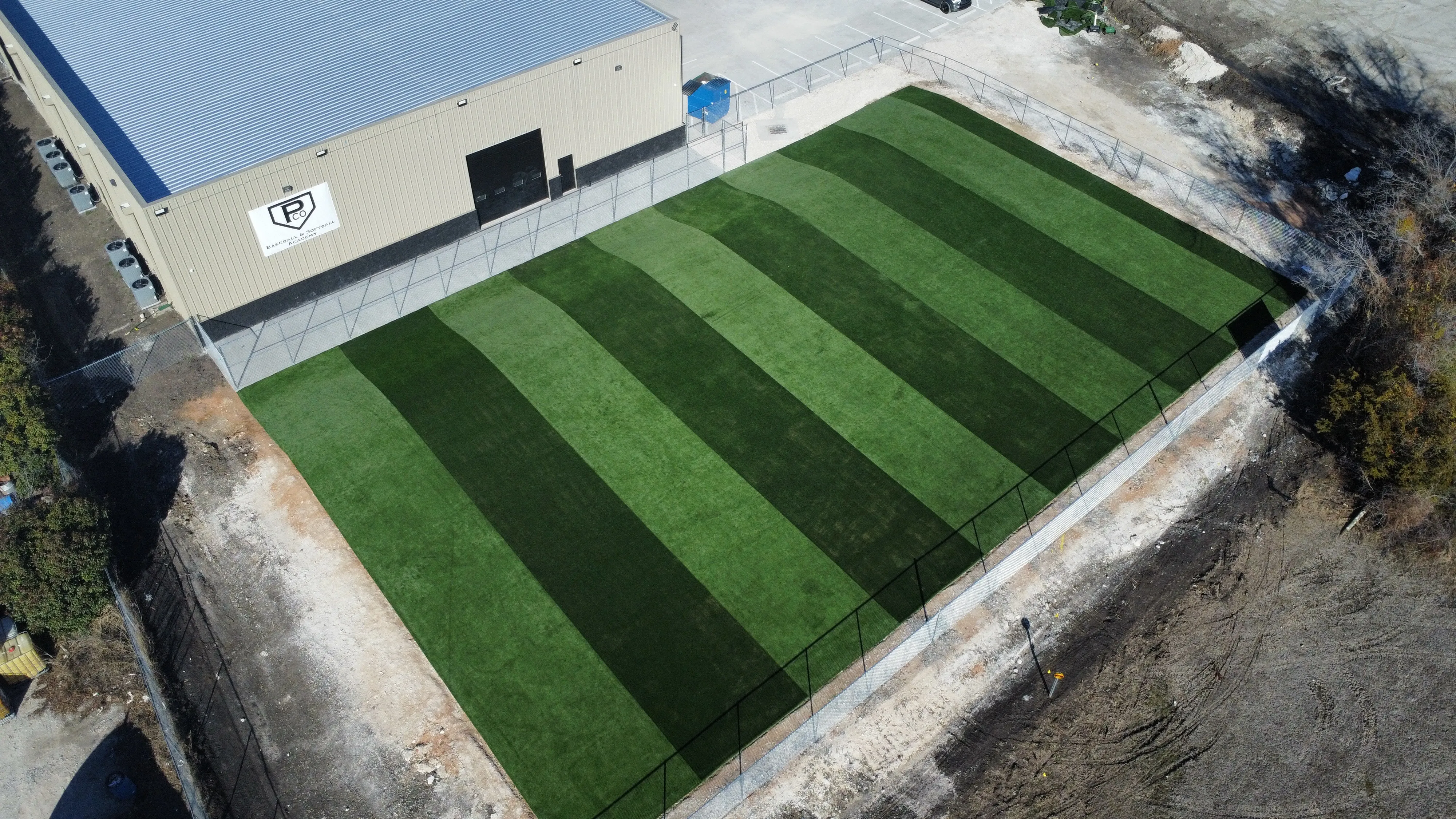 Aerial of Parker County Baseball & Softball Academy striped turf field showing full fenced footprint