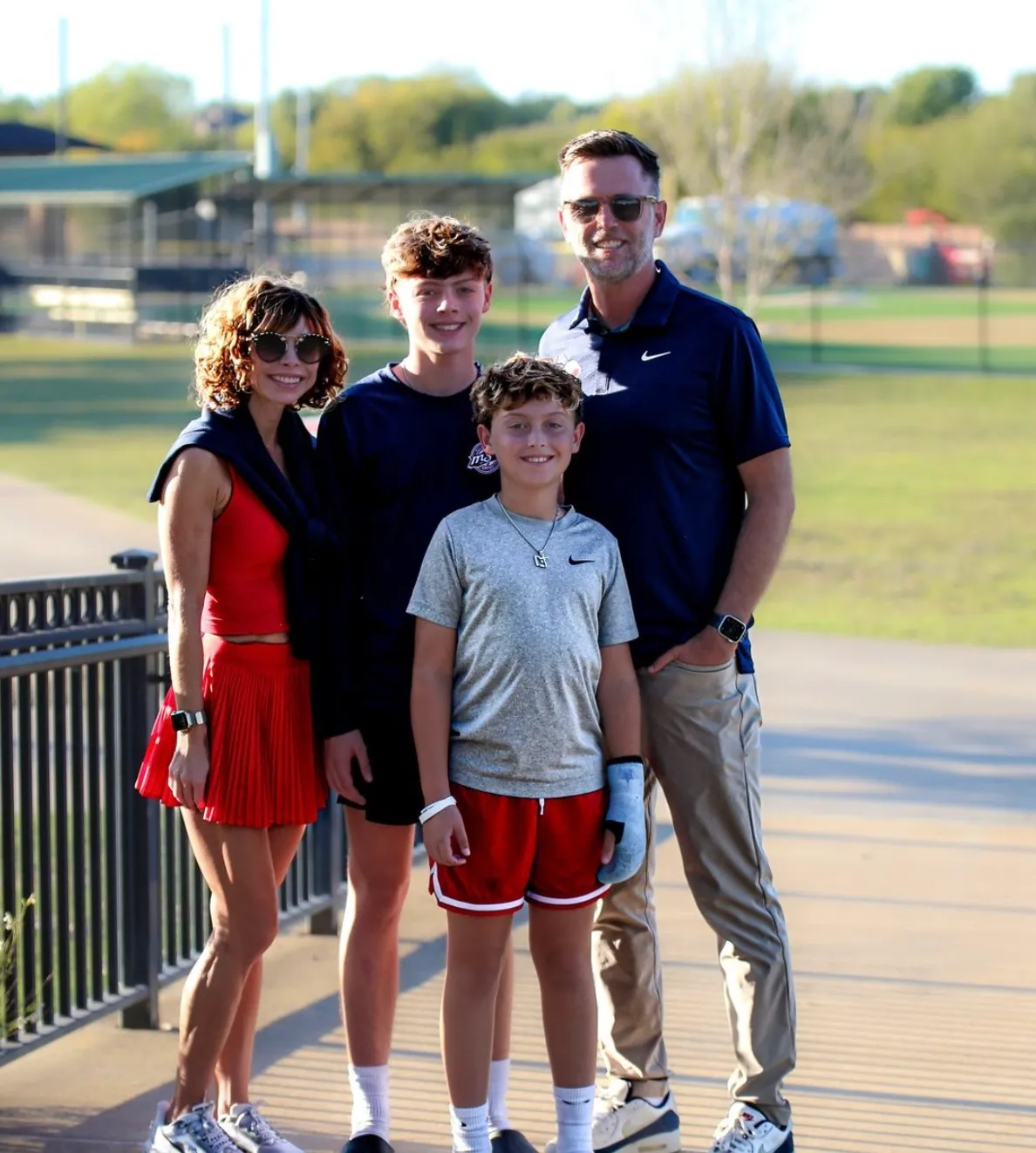 Lindsey, Colin, and their two sons at a North Texas ballpark