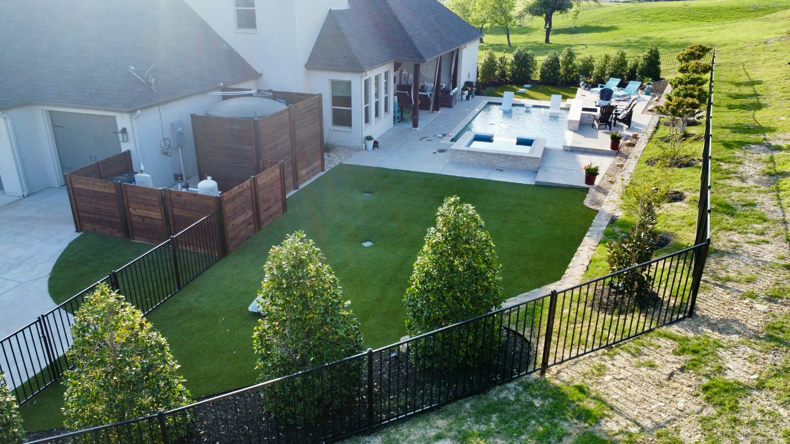 Bearcat-built complete backyard with pool, turf, decking, and outdoor living