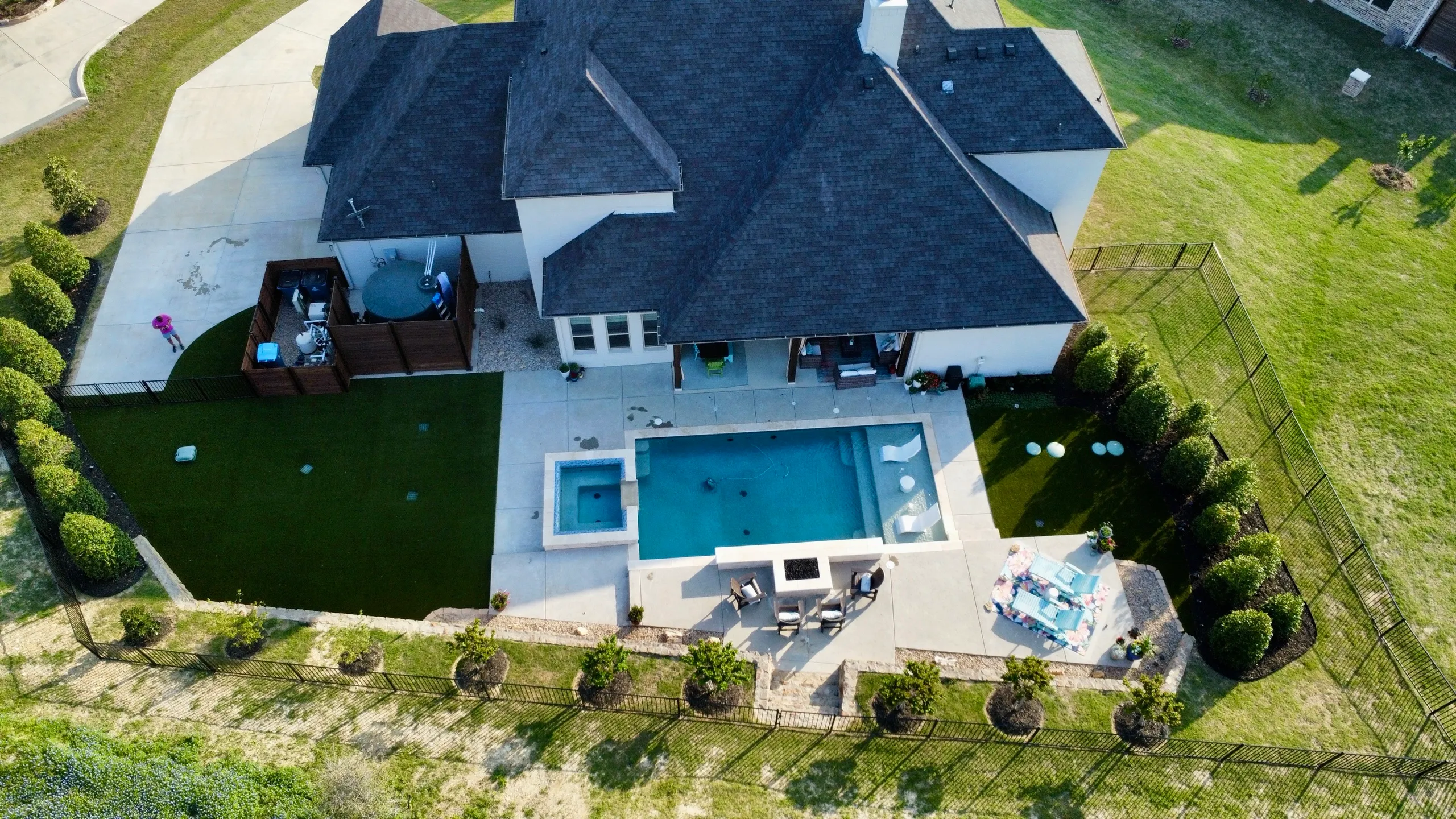 Aerial view of a Bearcat Turf & Outdoors poolside install with paver-and-turf pattern in DFW