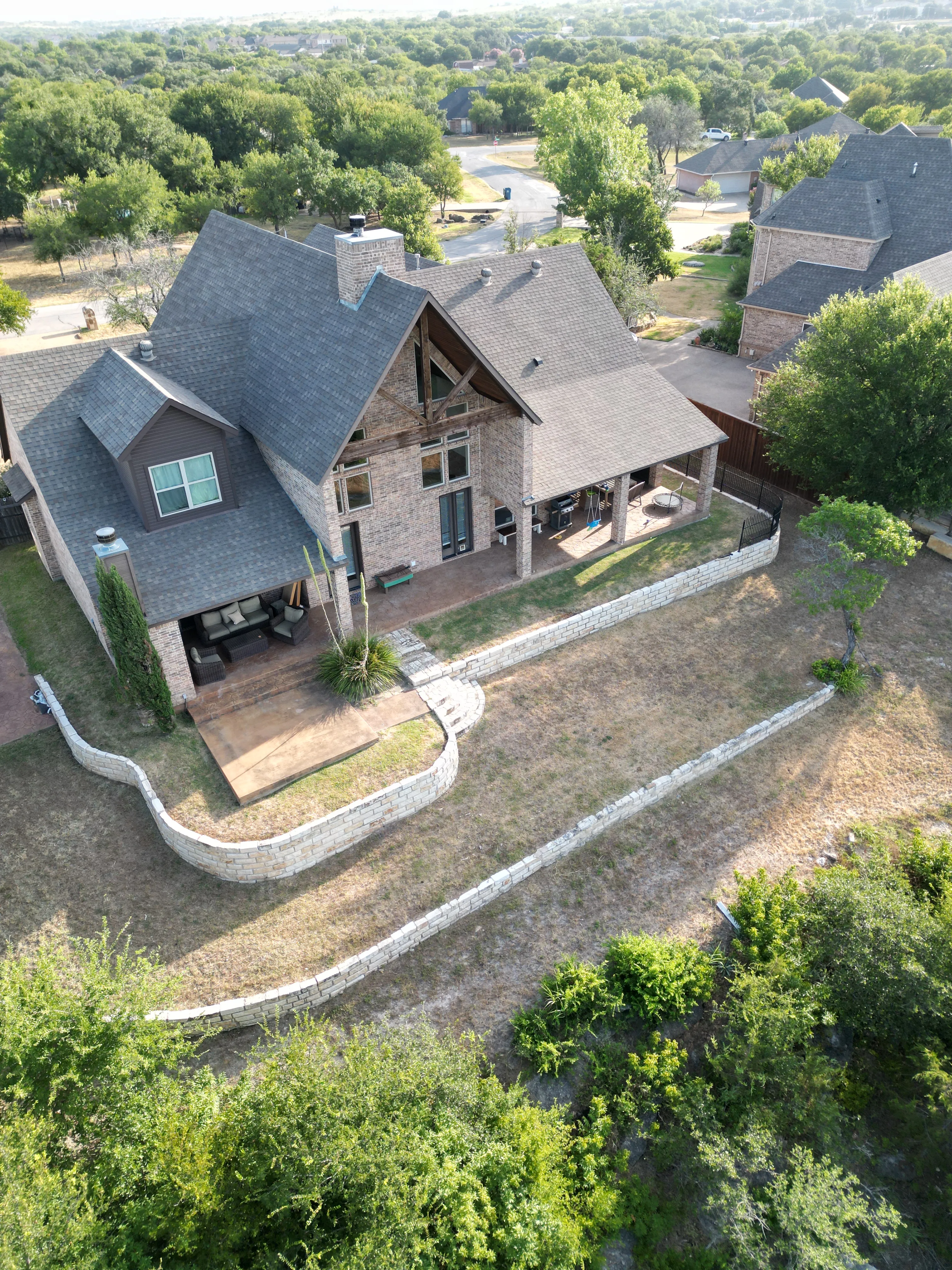 Before 3 — Aledo tiered backyard build: 606 SF Millsap retaining wall + 5,600 SF Bermuda Pro turf