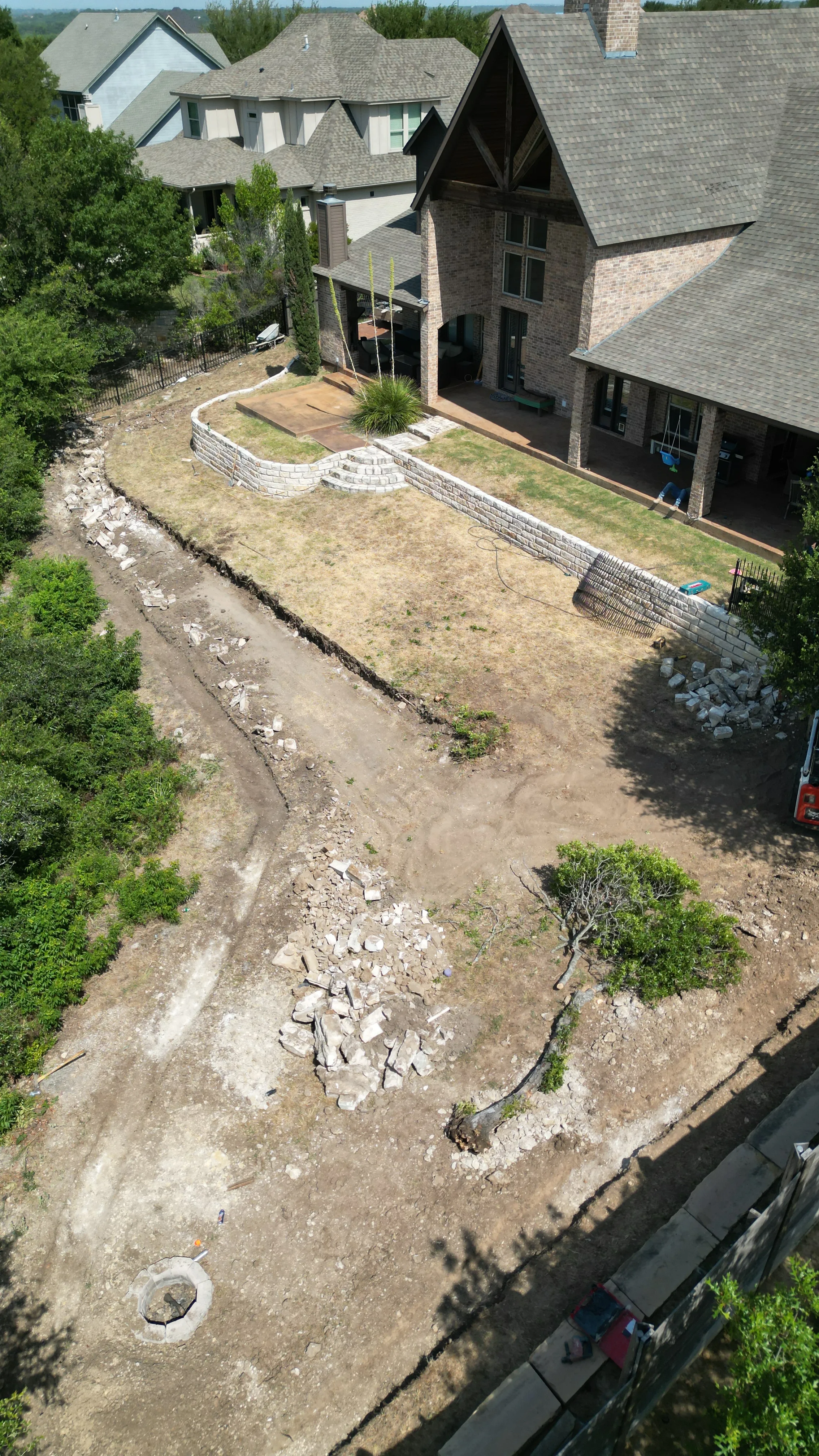 Construction 3 — Aledo tiered backyard build: 606 SF Millsap retaining wall + 5,600 SF Bermuda Pro turf