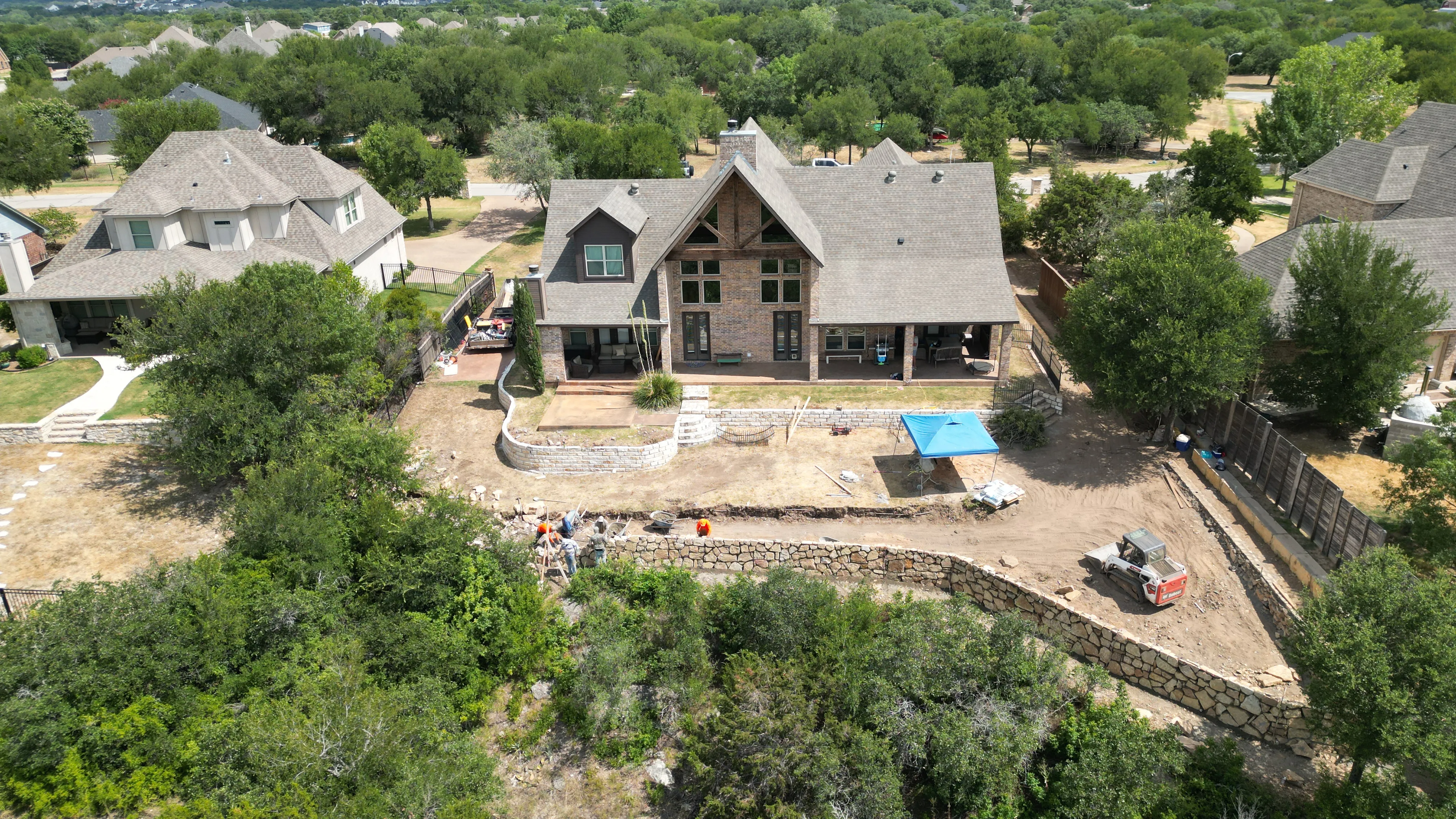 Construction 4 — Aledo tiered backyard build: 606 SF Millsap retaining wall + 5,600 SF Bermuda Pro turf