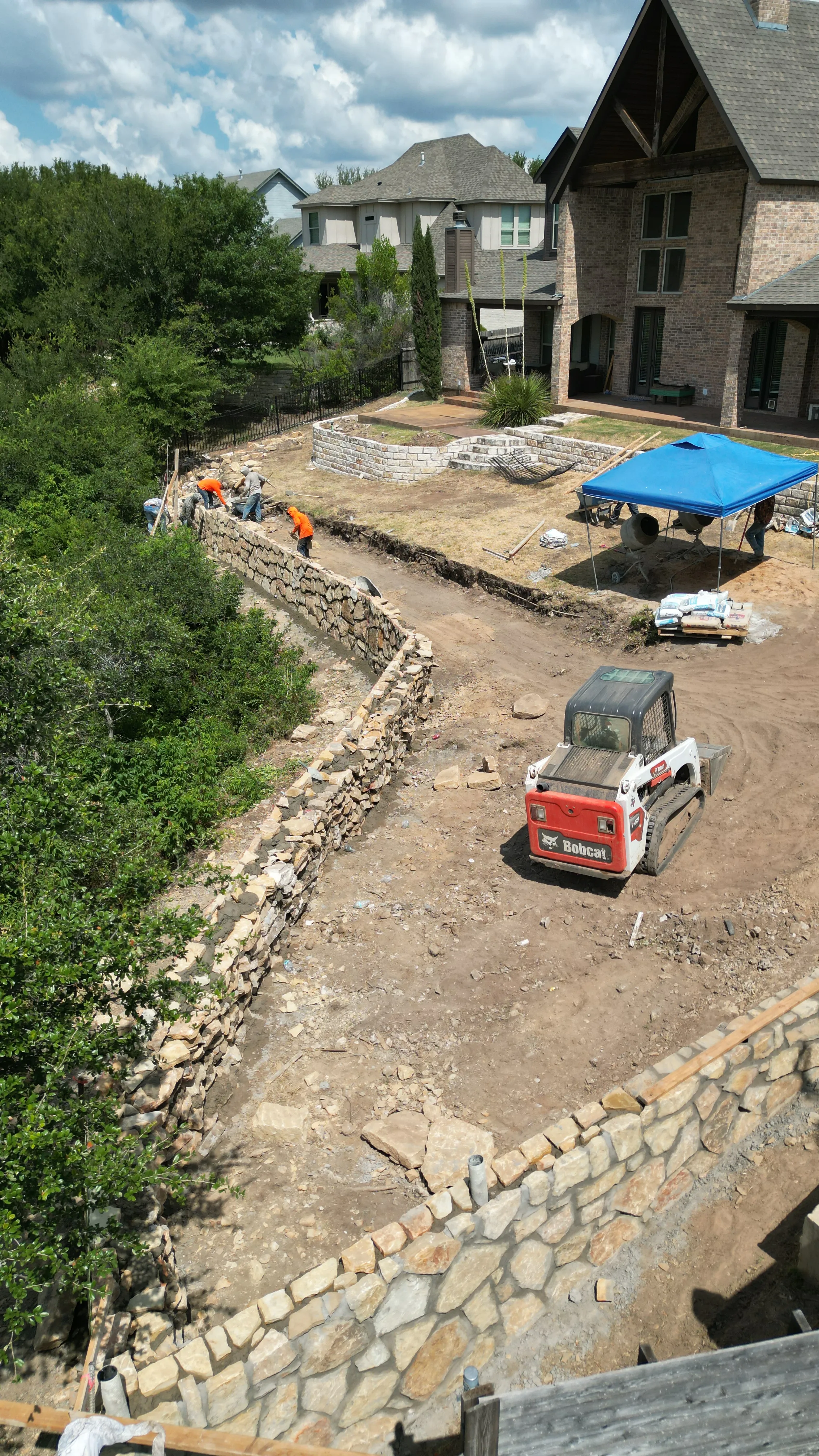 Construction 5 — Aledo tiered backyard build: 606 SF Millsap retaining wall + 5,600 SF Bermuda Pro turf