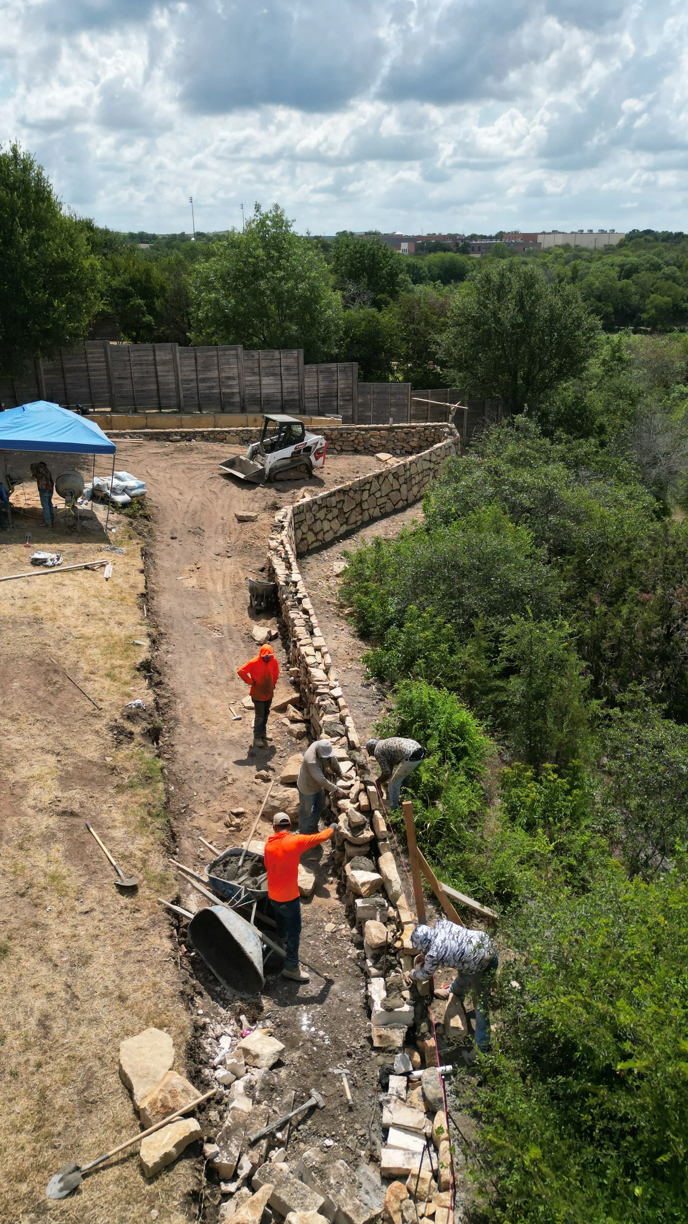 Construction 6 — Aledo tiered backyard build: 606 SF Millsap retaining wall + 5,600 SF Bermuda Pro turf