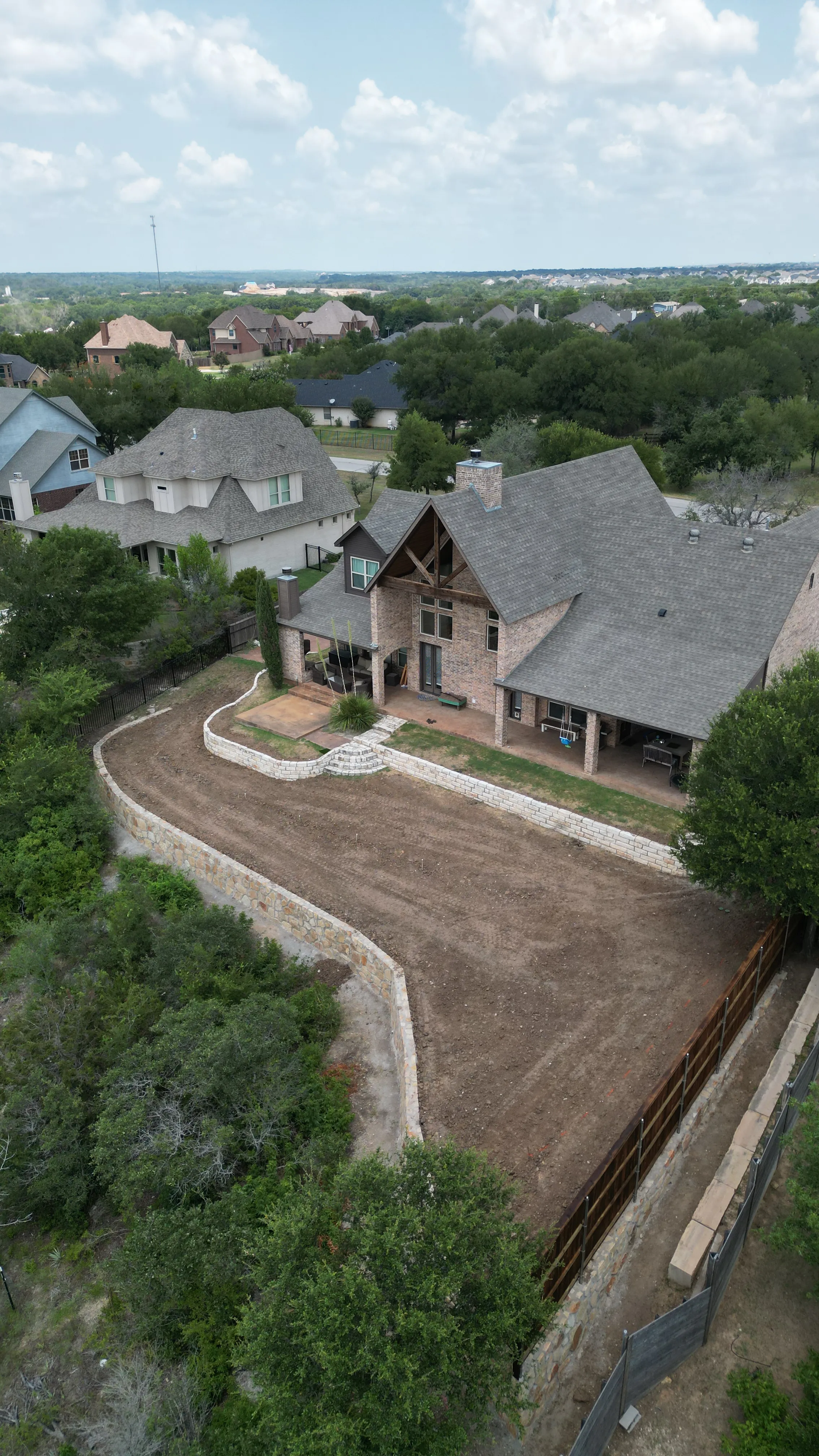 Construction 7 — Aledo tiered backyard build: 606 SF Millsap retaining wall + 5,600 SF Bermuda Pro turf