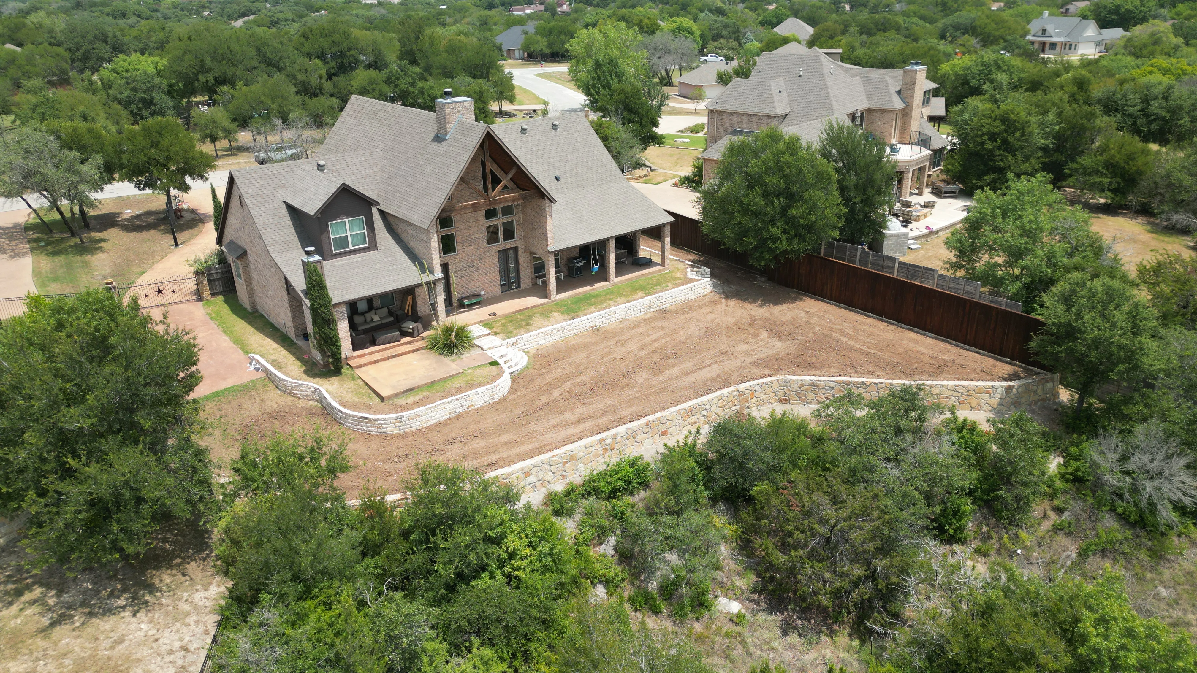 Construction 8 — Aledo tiered backyard build: 606 SF Millsap retaining wall + 5,600 SF Bermuda Pro turf