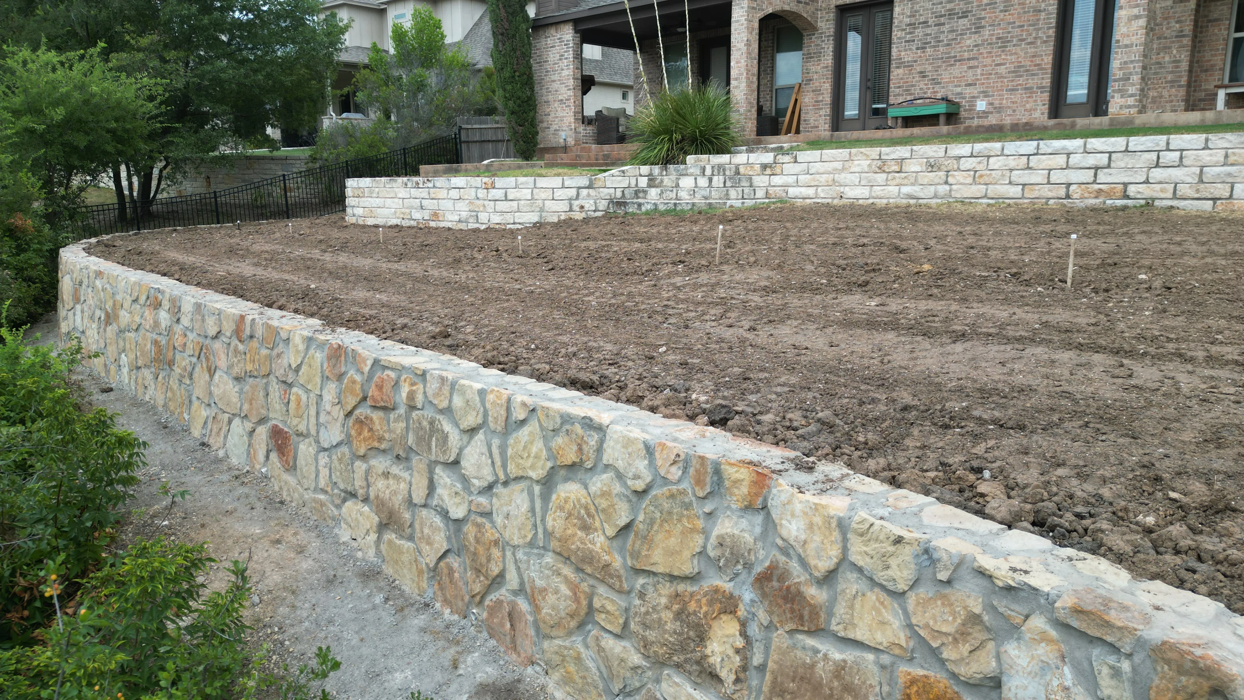 Construction 11 — Aledo tiered backyard build: 606 SF Millsap retaining wall + 5,600 SF Bermuda Pro turf