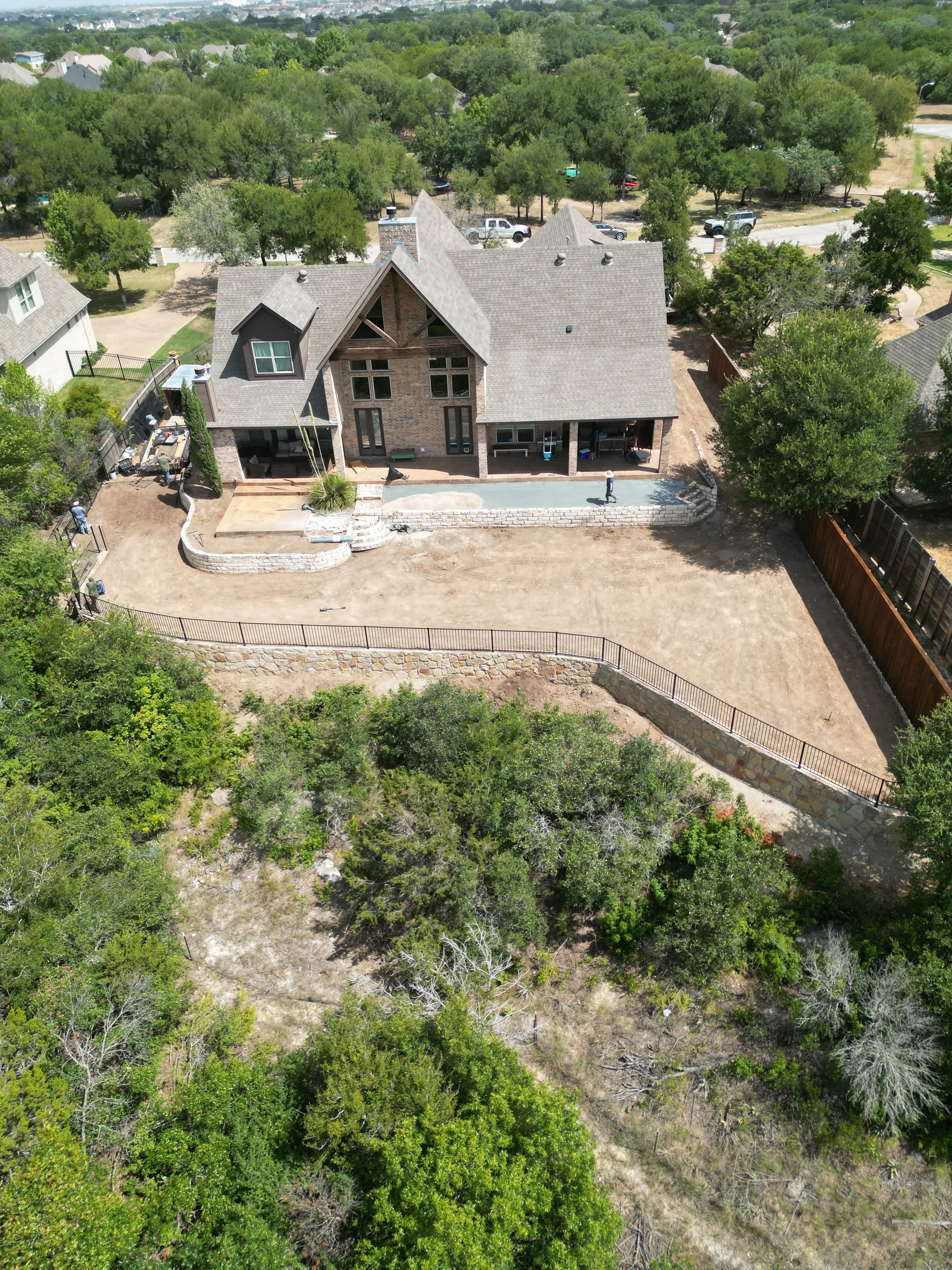 Construction 13 — Aledo tiered backyard build: 606 SF Millsap retaining wall + 5,600 SF Bermuda Pro turf