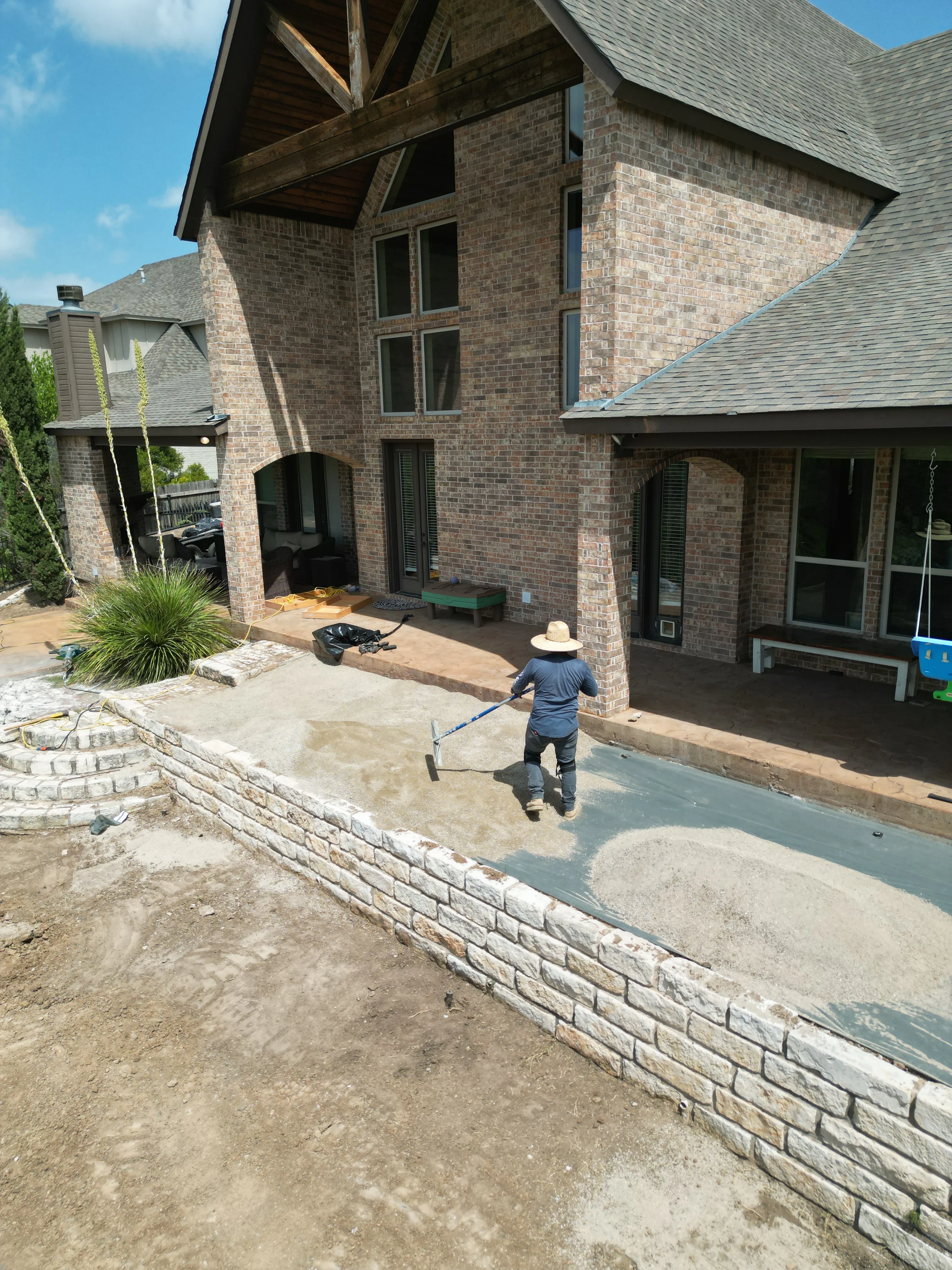 Construction 14 — Aledo tiered backyard build: 606 SF Millsap retaining wall + 5,600 SF Bermuda Pro turf