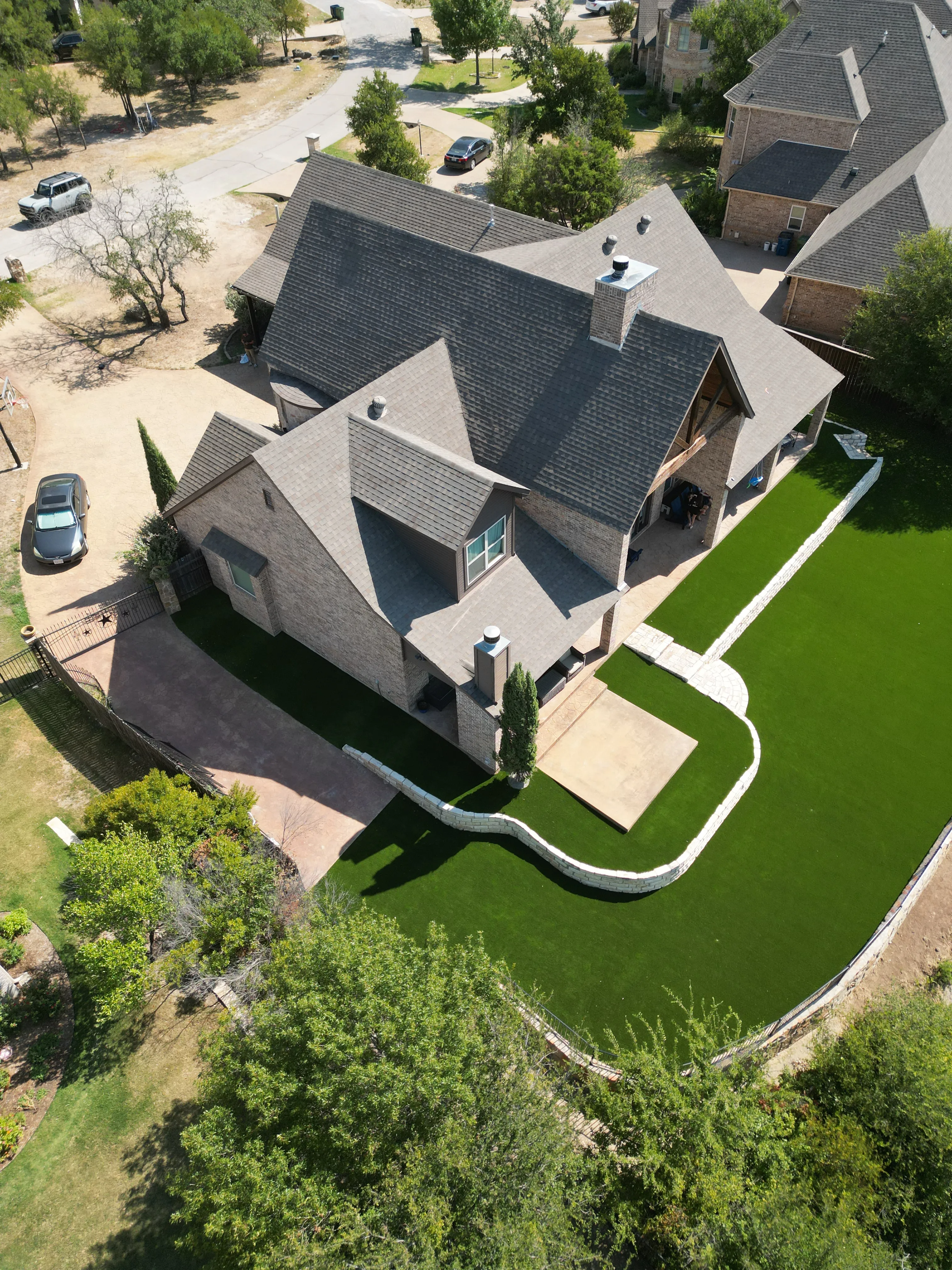 After 5 — Aledo tiered backyard build: 606 SF Millsap retaining wall + 5,600 SF Bermuda Pro turf