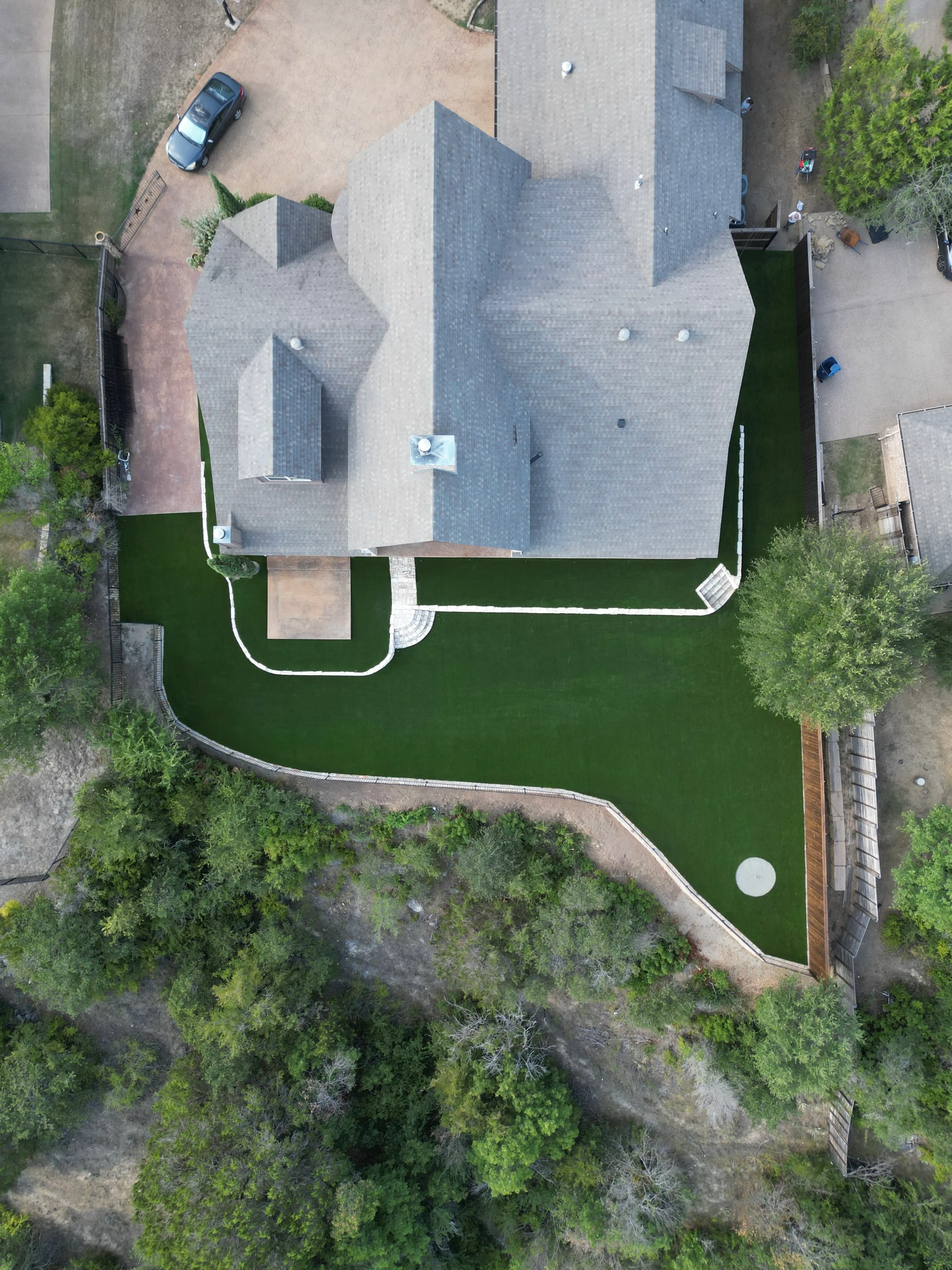 After 10 — Aledo tiered backyard build: 606 SF Millsap retaining wall + 5,600 SF Bermuda Pro turf