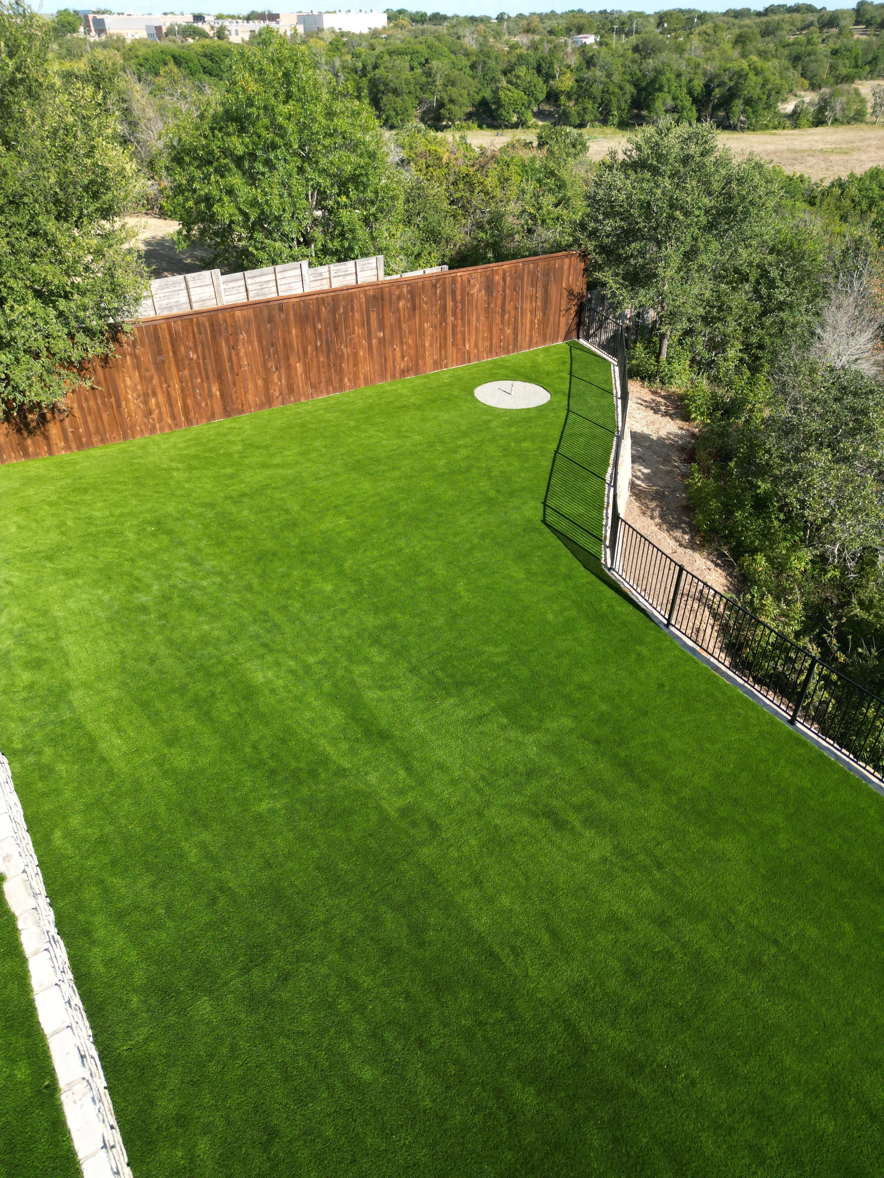 After 14 — Aledo tiered backyard build: 606 SF Millsap retaining wall + 5,600 SF Bermuda Pro turf