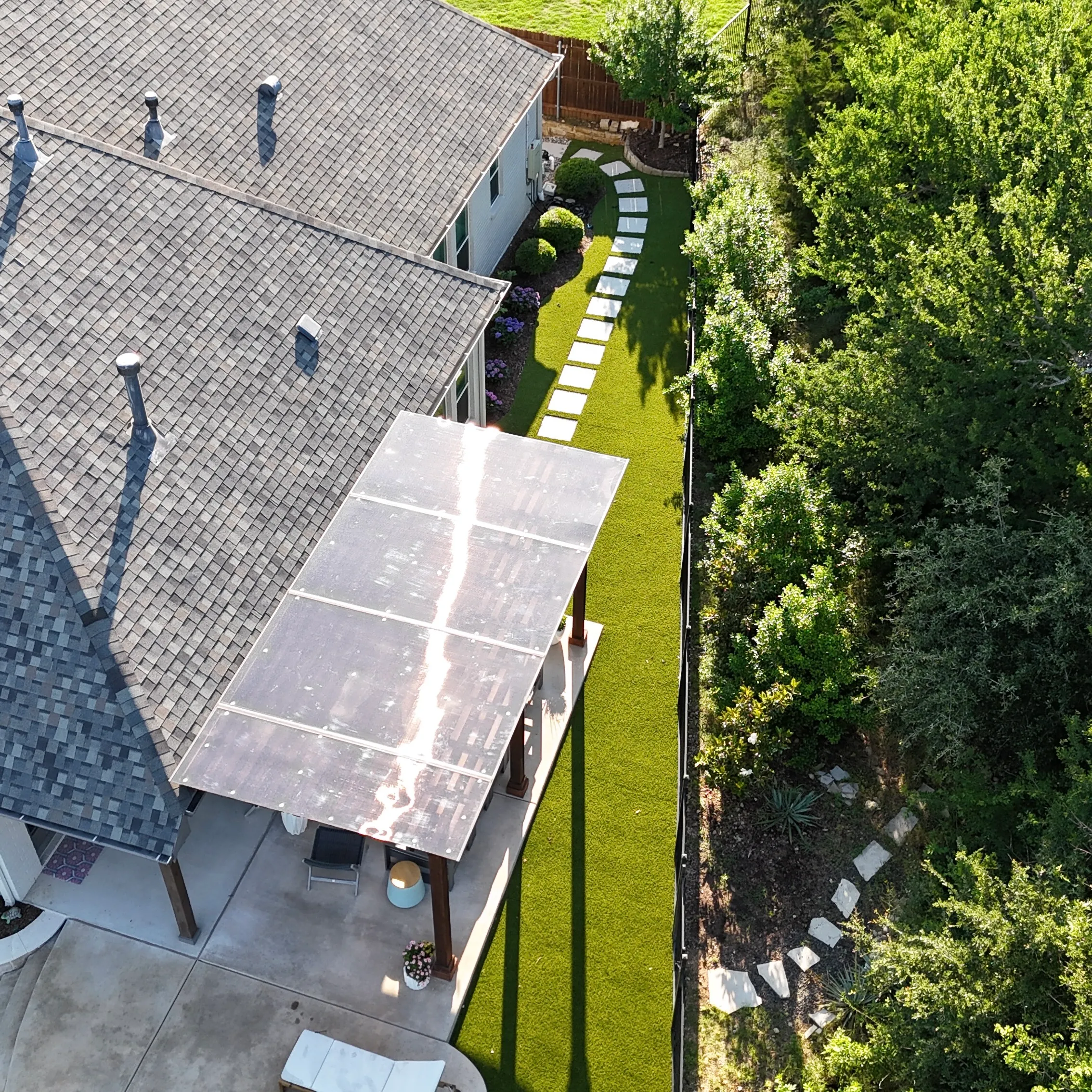 After 7 — Parks of Aledo backyard conversion: 1,750 SF of turf that disappears into the greenbelt, plus a paver walkway